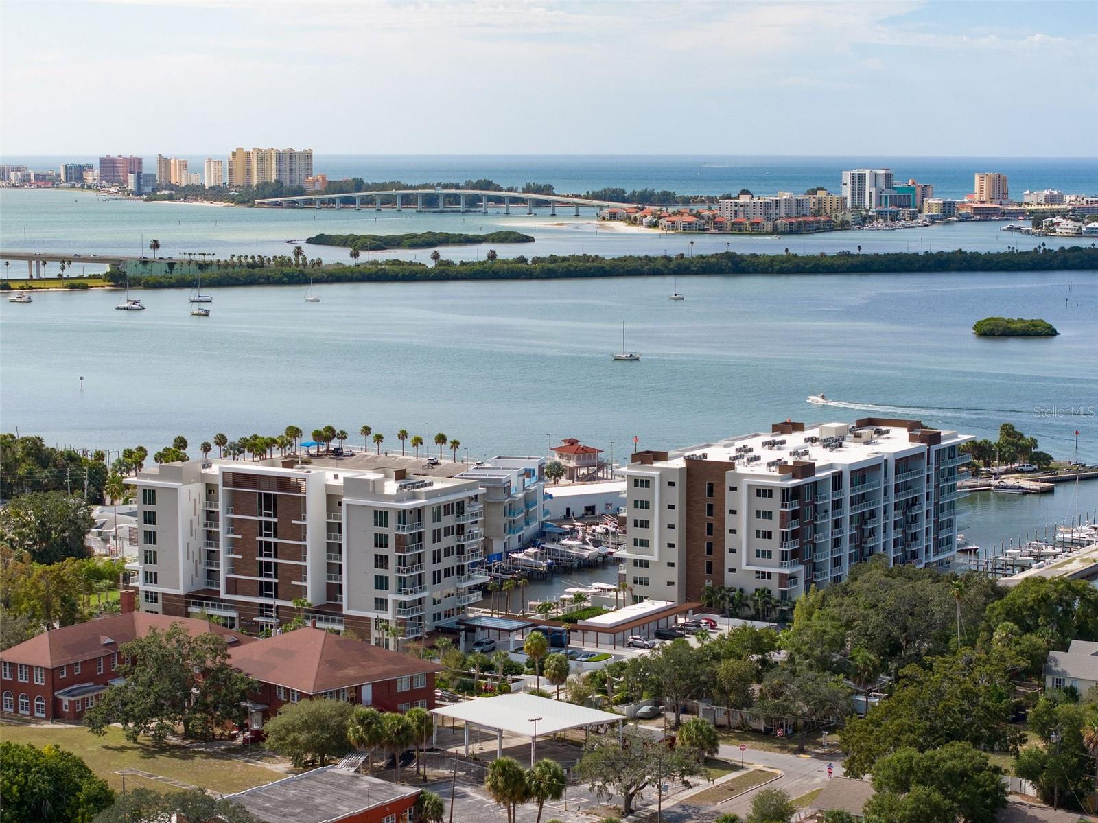 Call this amazing corner unit with stunning intracoastal and western facing water views home! Located on the 6th floor, southwest corner of the Poolside Building at the brand new Marina Bay 880 in Downtown Clearwater. Enjoy the marina, dolphins, beach sunsets and 4th of July fireworks from nearly every room in your home! The condo is tastefully furnished with modern and comfortable design. Enjoy a remarkable kitchen with quartz counters, GE cafe series appliances and a water filtration system. With it's split floor plan the primary suite is a perfect sanctuary with water views out of the floor-to-ceiling windows, walk-in closets and beautiful bathroom. The third bedroom is currently arranged as an office but you could easily add a bed to the space. Condo comes with 2 assigned parking spaces in the parking garage and use of all the amazing amenities such as pool, putting green, fitness center, conference room and 24 hour concierge. Arrange your showing today of this perfect Florida home!