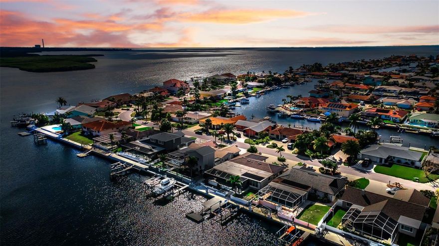 Experience the ultimate Gulf Coast lifestyle in this beautifully updated waterfront pool home located on one of the widest and deepest canals in Gulf Harbors. With direct access to the open Gulf and private beach privileges, this property offers a rare combination of serious boating capability and exclusive beachfront enjoyment.

Situated on a deep-water canal (approximately 15-20 feet), this home accommodates large vessels with ease. The expansive canal width allows for a 50+ foot yacht to be positioned perpendicular to the seawall. The composite dock system includes a 10,000 lb boat lift with recently replaced carriage and two new motors, plus a floating dock for added versatility.

The outdoor living space is designed for year-round enjoyment. The pool and spa were refinished in 2018 and are complemented by travertine pavers and tile throughout the pool area. State-of-the-art pool equipment includes both heat pump and solar heating. A 20/20 screened enclosure surrounds the pool area, offering exceptional protection while maintaining open views. An outdoor shower completes the coastal experience.

The 2025 remodel enhanced both function and curb appeal. The double driveway provides expanded parking capacity, and pavers surround the home extending to the seawall. All gutters are routed underground for improved drainage. Additional updates include a new flat roof (2017), new garage door opener (December 2025), blown-in attic insulation (2017) for energy efficiency, new water softener and whole-house filtration system, and power blackout shades in the main living area.

Two separate water meters service the property—one dedicated to the home and a second for landscape, pool, and dock use—helping reduce sewer charges. An in-ground propane tank is installed and plumbed to the home (currently not in use).

In addition to exceptional boating access, residents have the option to join the private Gulf Harbors Beach Club, offering sandy shoreline, pavilions, grills, and some of the most spectacular sunset views on Florida’s west coast.

This is more than a waterfront home. It is a deep-water boating property with exclusive Gulf beach access—an uncommon and highly desirable combination.