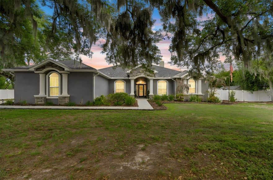 Welcome to your private slice of Florida living in Plant City- where modern luxury meets space, comfort and resort style amenities. Offered at $869,000. this beautifully crafted 2018 home sits on over an acre (1.03 acres) of fully fenced land, complete with a paved driveway and automatic gated entry. The property combines elegance and functionality, featuring both an attached 2-car garage and a 2-car detached garage with an oversized carport-perfect for additional vehicles, boats, or recreational storage. You'll also find four spacious storage sheds and a full 50- amp RV hookup, making this property as practical as it is stunning. 
Inside the home offers 2742 square feet of thoughtfully designed living space (3763 total covered square feet including outdoor areas), highlighted by soaring 10- foot ceilings, crown moulding and ceiling fans in every room. The layout includes three bedrooms ,three bathrooms, a dedicated office with glass pocket doors, a living/media room and a separate Great room-giving you flexibility for both entertaining and every day living. 
The heart of the home is the expansive chef's kitchen, featuring a massive quartz island (Over 9 feet long), marble-look countertops, quiet-close cabinetry, double ovens, and a built-in beverage/wine cooler. The open design flows seamlessly into the great room, where a lit tray ceiling and a wood burning stone fireplace create a warm, inviting atmosphere.
The primary suite is a true retreat , complete with. A lit tray ceiling automatic shade, dual walk-in closets, and a luxurious en-suite bath featuring separate vanities, a garden tub, a large glass shower, and a private water closet.
Step outside and experience you're own backyard oasis. The custom saltwater pool is designed for relaxation and entertaining, with a sunshelf (complete with bubbler and umbrella holder), built-in table curved bench seating, and a swim-out area. A connected hot tub spills over into the pool via a tranquil waterfall. The entire pool/Lanai area is screened-in and finished with pavers and a travertine lanai, enhanced by an exterior sound system for the perfect atmosphere.
Additional highlights include plantation shutters on all front and side windows, a comprehensive security system with cameras and programmable front door lock, and a beautifully landscaped yard anchored by a grand oak tree. (The topical landscaping is poised to bounce back after the recent cold weather.)
This exceptional property offers the perfect blend of privacy, luxury, and functionality- all within reach of everything Plant City has to provide.
Scheduled your private showing today and discover what makes this home truly special.