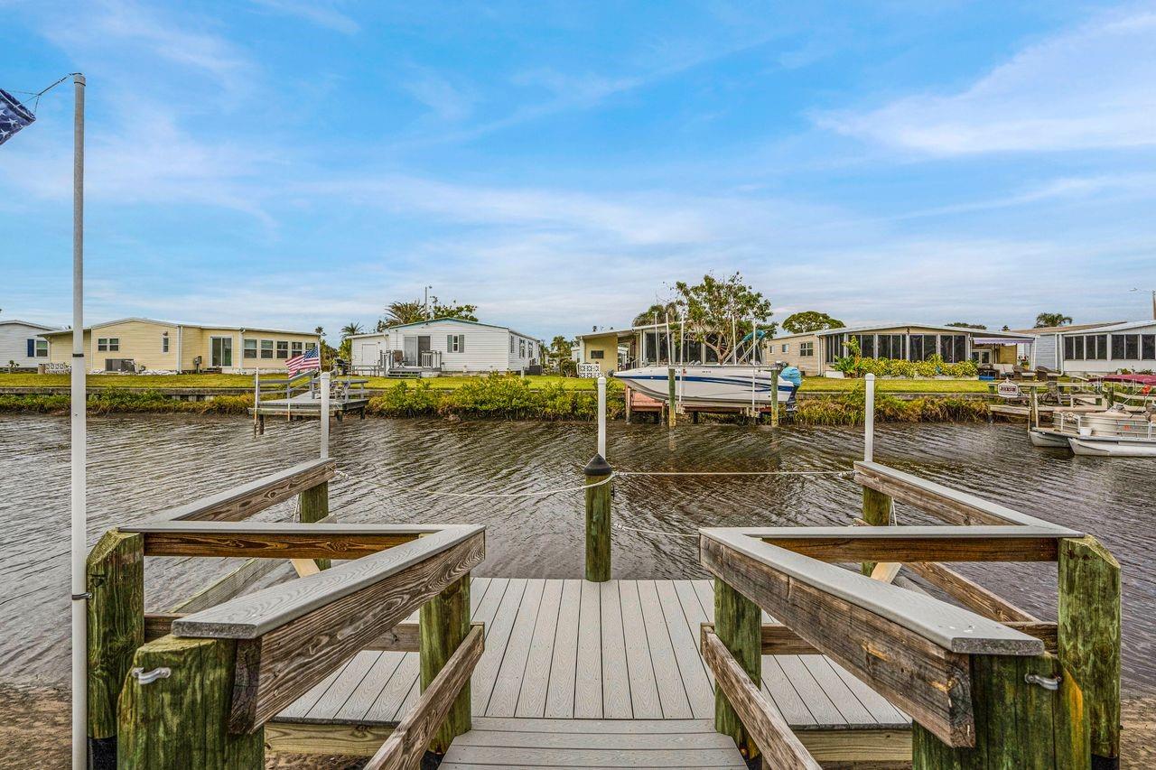 NEW PRICE! - Excellent Value on this Updated CANAL FRONT retreat with DOCK and GULF ACCESS in Harbor Cove! Most exterior and primary systems in this home have been updated. Discover comfort and tranquility in this furnished 2-bedroom, 2-bath + den home, plus golf cart, located in an amenity rich 55+ community along the Myakka River. Bring your boat and enjoy the benefit of leaving right from your own backyard dock. Step inside to an open-concept living, dining and kitchen area with tons of natural light. The kitchen features attractive countertops, easy access slide-out drawers and an island for extra prep space with convenient dining table nearby. The spacious living room is the perfect place to relax. Experience serene canal views from your large enclosed lanai with big windows to the outdoors (an additional 220 SF). Wake up in your primary bedroom with ensuite bathroom and savor those lovely water views. A bonus room is ideal for an office, art studio or extra sleeping space. The guest bath and 2nd bedroom doorways are wide enough for a wheelchair if necessary. Outside, return back to your private dock after a day or fishing or cruising and return later for a BBQ or unwinding on the patio. A covered driveway will fit multiple vehicles and there's a handy 15' x 8' shed. Recent upgrades include a new A/C system, washer and dryer (2024), new roof, ceilings and lighting (2023), updated breaker box and lanai mini-split (2022) and more. Low monthly HOA fees of $150 grant access to two pools, a spa, fitness center, tennis, bocce and pickle ball plus lawn mowing and seawall maintenance. Make friends at dances, parties and classes at the impressive clubhouse overlooking the marina. Nature lovers will enjoy the lush landscaping and plentiful wildlife viewing opportunities. Just a short drive from beautiful beaches, restaurants, farmers markets, street festivals, shopping and hospitals. NOW is the time to pick up this waterfront oasis and make it your home—schedule a showing today!