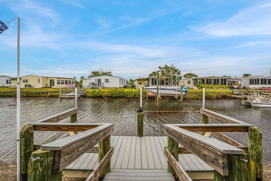 NEW PRICE! - Excellent Value on this Updated CANAL FRONT retreat with DOCK and GULF ACCESS in Harbor Cove! Most exterior and primary systems in this home have been updated. Discover comfort and tranquility in this furnished 2-bedroom, 2-bath + den home, plus golf cart, located in an amenity rich 55+ community along the Myakka River. Bring your boat and enjoy the benefit of leaving right from your own backyard dock. Step inside to an open-concept living, dining and kitchen area with tons of natural light.  The kitchen features attractive countertops, easy access slide-out drawers and an island for extra prep space with convenient dining table nearby. The spacious living room is the perfect place to relax. Experience serene canal views from your large enclosed lanai with big windows to the outdoors (an additional 220 SF). Wake up in your primary bedroom with ensuite bathroom and savor those lovely water views. A bonus room is ideal for an office, art studio or extra sleeping space. The guest bath and 2nd bedroom doorways are wide enough for a wheelchair if necessary. Outside, return back to your private dock after a day or fishing or cruising and return later for a BBQ or unwinding on the patio. A covered driveway will fit multiple vehicles and there's a handy 15' x 8' shed. Recent upgrades include a new A/C system, washer and dryer (2024), new roof, ceilings and lighting (2023), updated breaker box and lanai mini-split (2022) and more. Low monthly HOA fees of $150 grant access to two pools, a spa, fitness center, tennis, bocce and pickle ball plus lawn mowing and seawall maintenance. Make friends at dances, parties and classes at the impressive clubhouse overlooking the marina. Nature lovers will enjoy the lush landscaping and plentiful wildlife viewing opportunities. Just a  short drive from beautiful beaches, restaurants, farmers markets, street festivals, shopping and hospitals. NOW is the time to pick up this waterfront oasis and make it your home—schedule a showing today!