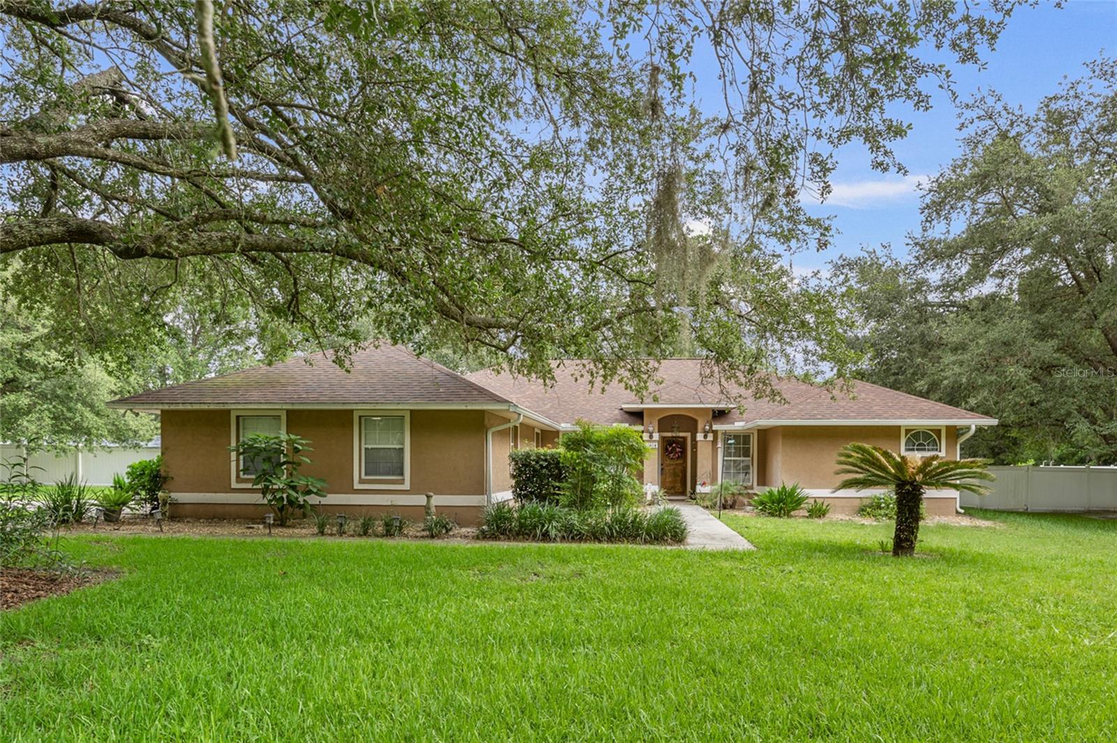 Amazing 4 bedroom/3 bathroom concrete block home in Parker Place seated on a corner lot with over 1 acre of land and beautiful oak trees. Home features an open layout with vaulted ceilings, lots of windows for natural light, and has been beautifully updated with LVP flooring in the main areas, an updated kitchen with butcher block countertops, completely renovated bathrooms, new roof (2023), new HVAC (2023), and a new water heater. Spacious screened porch and large backyard with vinyl privacy fencing provides a perfect place to relax with friends and family. Additional features are a full 2-car garage with new openers, storage shed, and water treatment system. Parker Place is located in one of the most central areas of west Gainesville, across from Oakmont and just minutes from Town of Tioga, restaurants, gyms, and grocery stores. Come make this piece of paradise your new home!