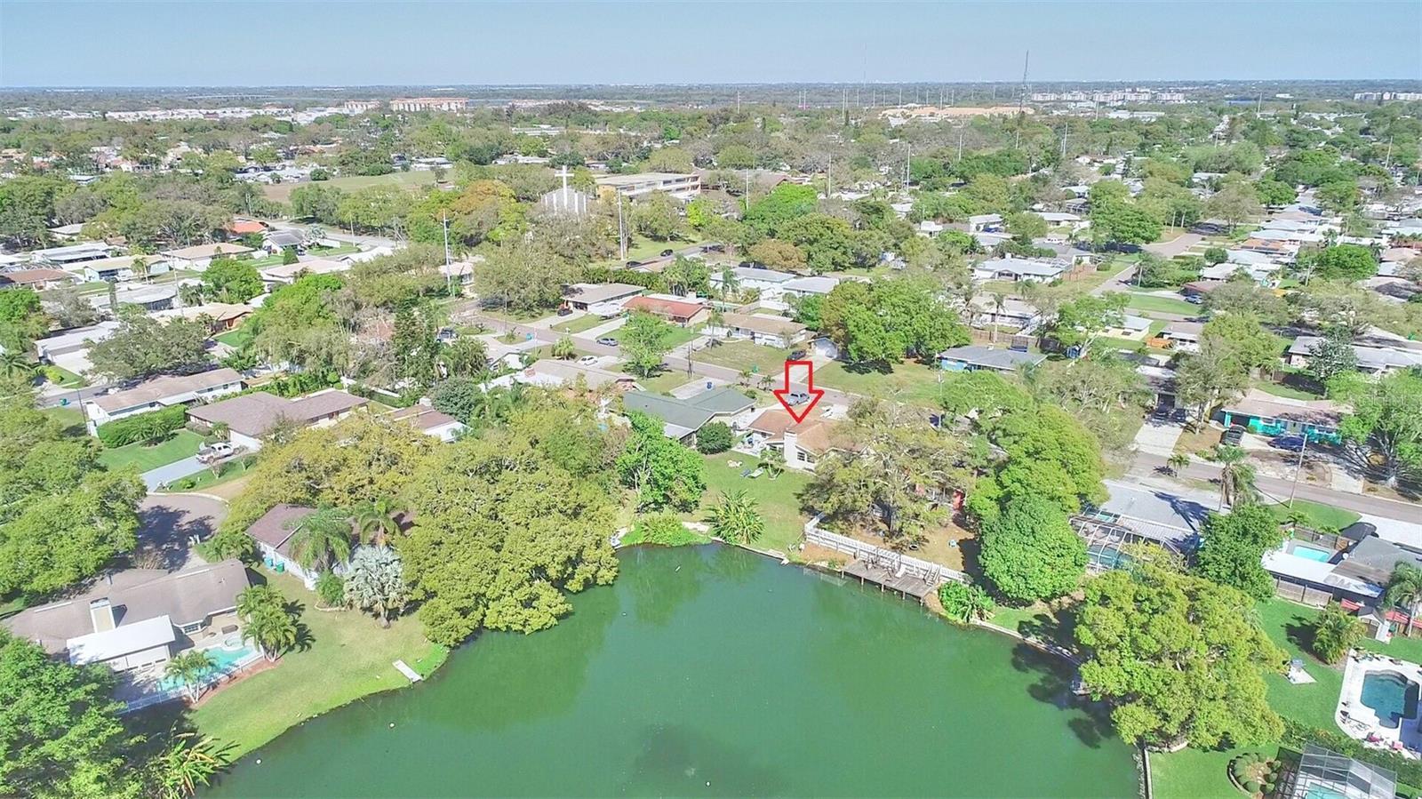 Enjoy lakeside living with this beautiful 3-bedroom, 2-bathroom single-family home in the heart of Seminole. A spacious and inviting open floor plan sets the tone for everyday comfort and seamless entertaining. Positioned on the tranquil shores of a picturesque lake, this property offers stunning water views, creating a serene backdrop for your daily life. Step outside to a large backyard, perfect for gatherings, play, or simply enjoying the outdoors, complete with a banana tree. Convenience meets style with a one-car garage and washer and dryer hookup, and there is a circular driveway ensuring ample parking. The modern kitchen is equipped with stainless steel appliances and Formica countertops. The home is complemented by laminate vinyl flooring throughout the entire home, and a cozy fireplace adds an extra touch of warmth and charm. Located just 5 minutes from the beach, shopping, restaurants, and more! Schedule your showing today; this property won't last long!