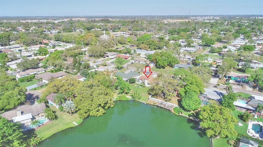 Enjoy lakeside living with this beautiful 3-bedroom, 2-bathroom single-family home in the heart of Seminole. A spacious and inviting open floor plan sets the tone for everyday comfort and seamless entertaining. Positioned on the tranquil shores of a picturesque lake, this property offers stunning water views, creating a serene backdrop for your daily life. Step outside to a large backyard, perfect for gatherings, play, or simply enjoying the outdoors, complete with a banana tree. Convenience meets style with a one-car garage and washer and dryer hookup, and there is a circular driveway ensuring ample parking. The modern kitchen is equipped with stainless steel appliances and Formica countertops. The home is complemented by laminate vinyl flooring throughout the entire home, and a cozy fireplace adds an extra touch of warmth and charm. Located just 5 minutes from the beach, shopping, restaurants, and more! Schedule your showing today; this property won't last long!