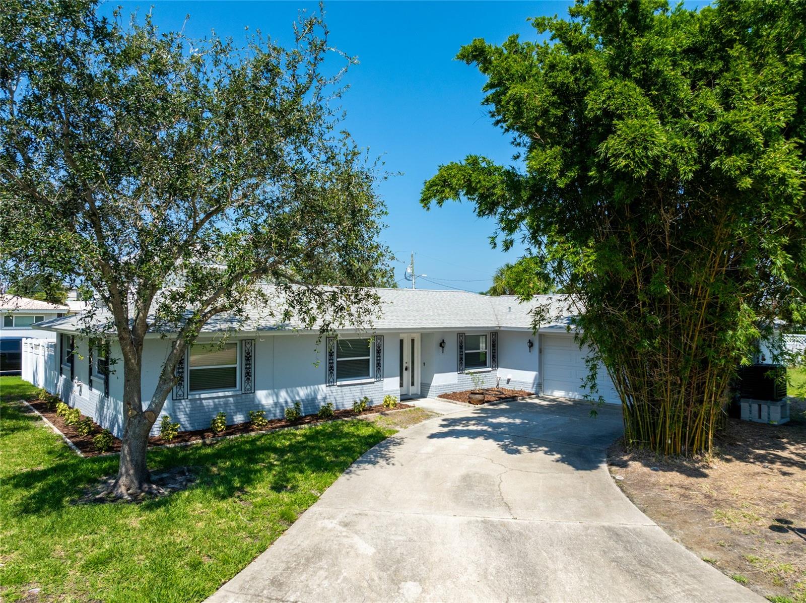 Beautifully renovated 3 bed, 2 bath, 2 car garage home on one of the largest lots in the Harbor View subdivision! Fully updated kitchen with new stainless steel appliances custom cabinets topped with quartz countertops. Both bathrooms feature new porcelain tile showers and vanities. All hot and cold water lines replaced with new hot water tank. New Goodman A/C system. All new interior doors with fresh paint throughout. Walking distance to the Dunedin Causeway and Honeymoon Island. Newer landscaping mixed with mature trees on property. Irrigation system is on reclaim water. This home was fully remediated, remodeled, and permitted by local licensed contractors. Don't miss this lovely Dunedin home, schedule your showing today!
