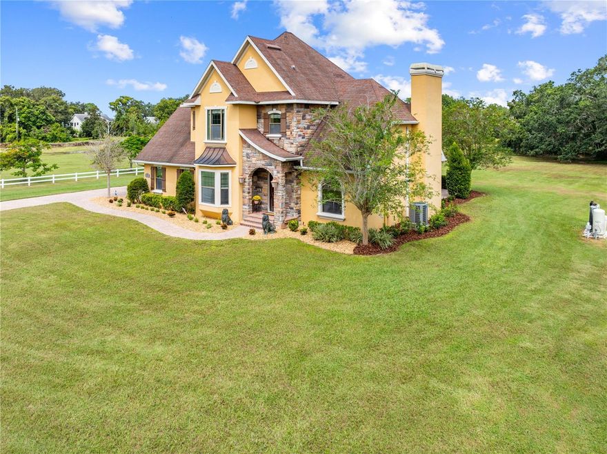 $20K SELLER CREDIT with a Full-Price Offer!
Discover the best of country living just minutes from Lake Nona in this exceptional, one-owner custom estate set on five oak-shaded acres. Built with pride and precision by renowned Central Florida builder Barry Bryant, this home blends timeless craftsmanship with modern efficiency—no HOA, no CDD, and solid concrete-block construction with foam-insulated walls for lasting quality and comfort.
A solid wood front door welcomes you into a light-filled interior featuring 10-foot ceilings, hardwood floors, and exquisite custom woodwork throughout. The private office offers floor-to-ceiling built-ins, while the formal dining room is highlighted by a bay window with bench seating—perfect for hosting family and friends.
The chef’s kitchen is designed for both function and style, showcasing 42-inch crown-molded cabinetry, granite countertops, a prep island with sink, hidden spice storage, and seamless flow into the spacious family room. Anchoring the space is a dramatic floor-to-ceiling stone fireplace, creating a warm and inviting centerpiece.
A downstairs guest bedroom with a full bath provides ideal accommodations for visitors or multigenerational living. Upstairs, the primary suite feels like a private spa retreat, complete with a soaking tub, walk-in shower, dual vanities, and a custom closet system.
Step outside to the expansive 25×50 covered lanai, where towering oaks and peaceful surroundings create the perfect backdrop for morning coffee or evening relaxation. Wildlife sightings are part of daily life—deer, wild turkeys, foxes, hawks, and even bald eagles. With five acres of natural beauty, there’s ample room to add a pool, summer kitchen, or outbuilding, along with space for RVs, boats, or recreational equipment.
Ideally located just minutes from SR-417, Medical City, top-rated schools, and Orlando International Airport, this property offers the rare balance of serene acreage living with the convenience of Lake Nona.
Move-in ready, built to last, and truly one of a kind. In a rapidly growing region, land is the one thing you can’t make more of—and it only grows more valuable with time.