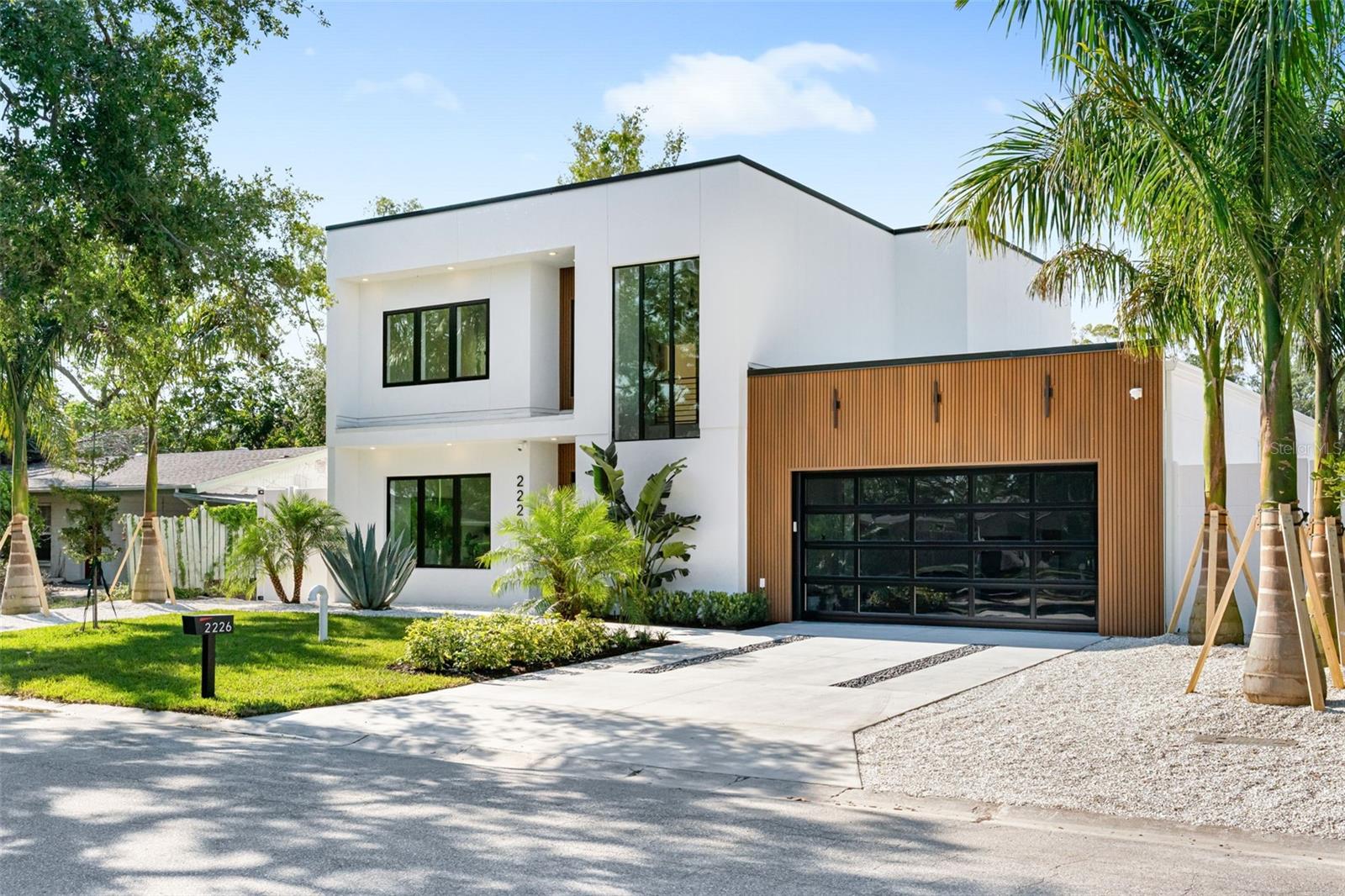 Modern refinement blends seamlessly with elegance and comfort in this stunning, new construction masterpiece from TDI Coastal Homes. An ideal location, this home is situated 10 minutes from the world famous Crescent beach on Siesta Key and just minutes to downtown Sarasota. Peace of mind is assured as this property is not in a flood zone and is perched a safe 21 feet above sea level. With a front facade that boasts clean lines and a captivating mix of wood, stone and a unique commercial style glass garage door, your curb appeal will be undeniable as you welcome family and friends into your sophisticated sanctuary. Cutting edge material and design does not sacrifice quality and durability as the engineered hardwood floors throughout the first floor create the perfect foundation for the exquisite open concept design. A chef’s kitchen, featuring Thermador appliances, quartz countertops, an oversized island, intriguing fixtures and a walk-in pantry, lies at the heart of the home and is undoubtedly where your guests will gather to enjoy your inspired culinary creations. Find respite in your primary suite that will envelope you in luxury as you rest and recharge from your days filled with Suncoast adventures. The first floor also offers a home office, mud room, laundry space and multiple sets of sliders to the outdoor oasis consisting of a spacious lanai with a fully appointed outdoor kitchen and multiple seating areas. The refreshing pool will keep you comfortable on sunny afternoons while the warm spa will soothe as the day fades into night. The second floor grants room for guests or additional personal space with three generous bedrooms; one bedroom with a private bath and two that share an adjoining bath. Additional features to include a mosquito misting system for added comfort, a two car garage, and a reverse osmosis system for clean, filtered ice and water. With an incredible location in a vibrant community and top notch schools just around the corner, this home offers the best of Sarasota, brimming with culture, recreation, convenience and the quintessential Florida lifestyle. TDI Coastal Homes creates homes to meet your lifestyle through innovative design and meticulous attention to creating a space that feels extravagant yet effortless.