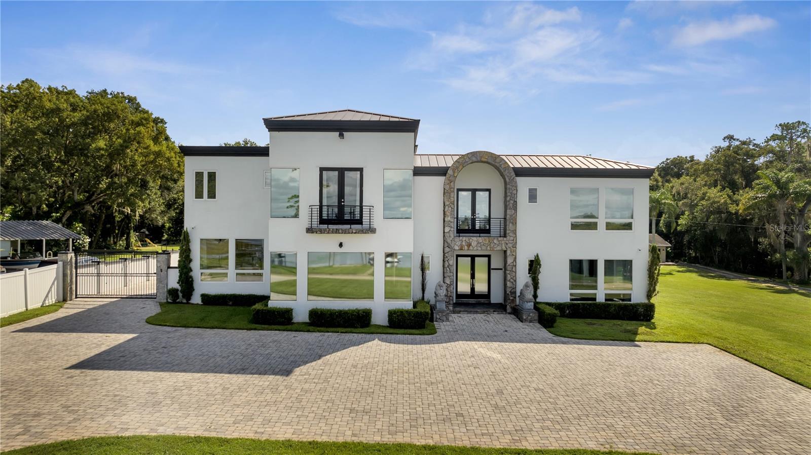Welcome to 736 Lake Winnemissett Drive in DeLand, Florida — a breathtaking 5,000-square-foot lakefront estate that seamlessly blends luxury, privacy, and convenience. Situated directly on the private Lake Winnemissett, this expansive property features its own dock and boat lift, a sparkling pool, relaxing spa, and best of all — no HOA.
The home features 4 bedrooms, 4 full bathrooms, and 2 half baths. The open-concept main living area is designed for comfort and entertainment, offering panoramic sunset views, a sleek modern kitchen, and a built-in bar. Upstairs, you'll find a state-of-the-art movie room with surround sound, multiple porches, and a spacious game room complete with a 110" TV — ideal for movies, sports, and gaming. Additional highlights include hardwired security cameras and Crestron smart home automation with whole-home audio.
Out back, a 1,200-square-foot air-conditioned workshop awaits, fully equipped with a car lift and additional storage — perfect for hobbyists, collectors, or extra utility space.
Recent upgrades over the past two years include brand-new HVAC systems, fresh interior and exterior paint, new appliances, and professionally tinted windows, ensuring both style and peace of mind.
Located just 35 minutes from Orlando and 25 minutes from Daytona Beach, this home offers the tranquility of lakefront living with easy access to major metro areas. Nestled in the heart of historic DeLand — home to Stetson University — you’ll also enjoy a vibrant community with charming shops, restaurants, and cultural attractions.
This is a rare opportunity to own a move-in-ready lakefront home on one of DeLand’s most desirable private lakes. Schedule your private showing today!