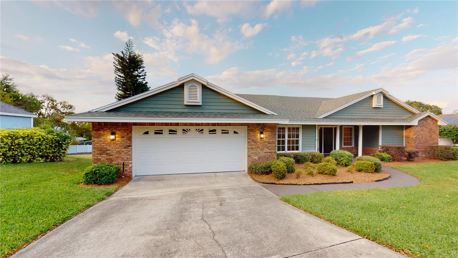 One or more photo(s) has been virtually staged. PRICE IMPROVEMENT ! Come see this beautiful 3BR/ 2B over 2400 sq ft Home. Welcome to Lake Mariam Shores, enter gates under a canopy of trees. This peaceful, small community of only 17 homes, in SE Winter Haven, is just off the beaten path, yet close to everything. Lots of restaurants, banks, groceries and healthcare facilities, and oh by the way Legoland is nearby. Don’t miss your opportunity to own this, home with split bedroom plan thats, pet and family ready with no carpet. Open the front door to a living room with a vaulted ceiling. High ceilings throughout. The Formal dining room is on your left, opens to an island kitchen with a large pantry. The owner’s bedroom and bath features a walk in closet ,and oversized double shower, and dual sink vanity and garden tub. Pocket doors open to a bonus room which could be used as an office, or nursery.
The spacious Florida-room, offers a panoramic distant Lakeview, also overlooking nice, backyard and raised deck. The home sits on .45 acre lawn with irrigation, newer St Augustine sod, and nice shrubbery. Home also features A/C with Natural gas heat, hot water and oversized two car garage. Make your appointment today, don’t miss out on this beautiful home in the most desirable corner of Winter Haven. Reasonable HOA. Contact me for your private showing.