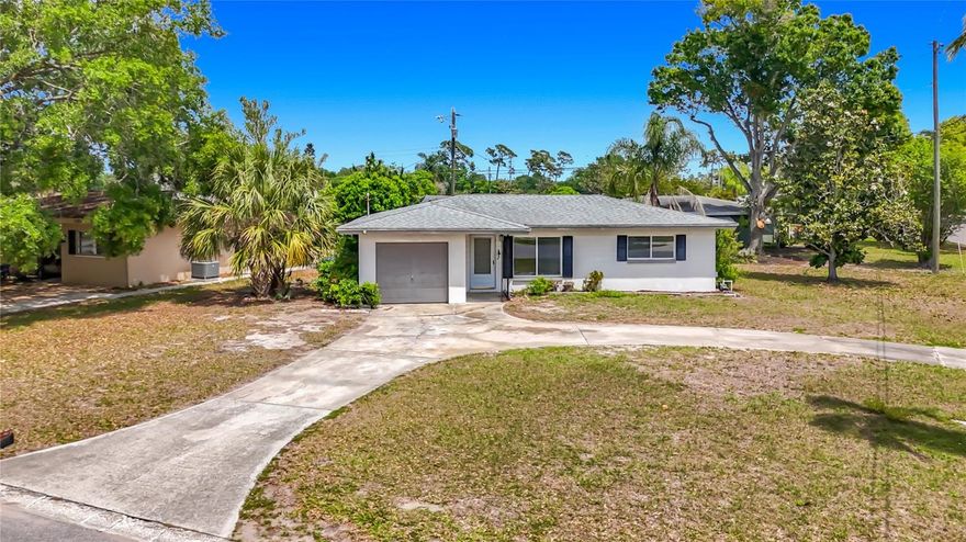 Opportunity to own a cute 2-bedroom, 1-bath home bursting with possibilities! Situated on an oversized corner lot, this property welcomes you with a stunning circular driveway that makes a statement from the moment you arrive.
Whether you're dreaming of a turnkey vacation rental, a cozy primary residence, or a smart investment property, this home is your blank canvas. Bring your vision and your contractor — a kitchen and bath remodel will transform this gem into something truly special. The bones are solid, the lot is generous, and the potential is undeniable.  A/C 2017, Water heater 2016, Back roof resealed 2023, Windows 2017