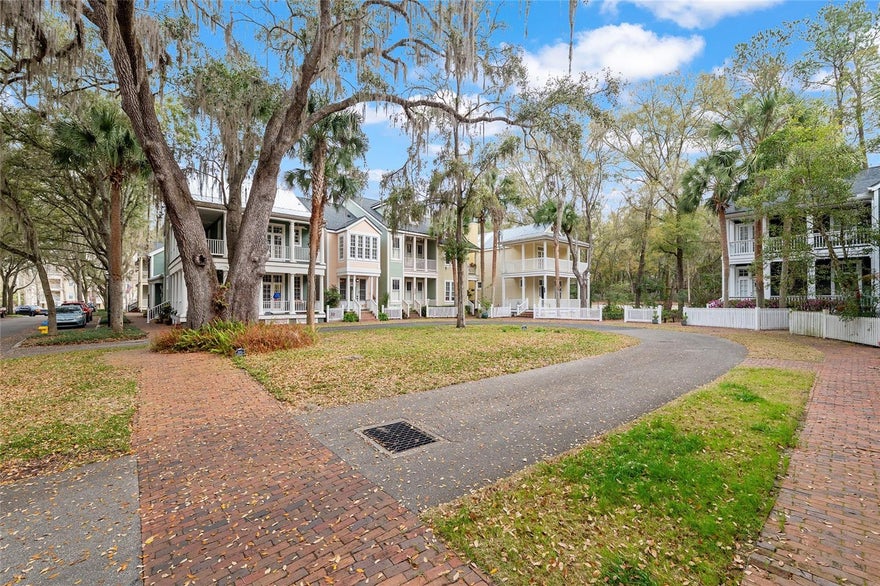 Located in the Village Center at Haile Plantation, this gorgeous 2bedroom 2.5 bath home is as quaint as it can be. With picturesque, tree-lined street with classic brick sidewalk and a green area to view from your front porch. A private drive loops around to welcomes you to your private sanctuary. This home has had many updates new master bath remodel ,wood floors, solid surface counter tops, newer painting inside and out, and plantation shutters. Opening the front door you feel the immediate charm that this home brings to you. With a guest room /office over your garage it is perfect for your visitors or as a home office. There is a third floor attic area that is being used as storage space but could be finishes into another room. Stepping outside the home you are just a few minutes walking to shops, restaurants, with sidewalks, and green spaces throughout the Village Center. Come see the charm of this southern style home, and have a seat on the front porch!!!