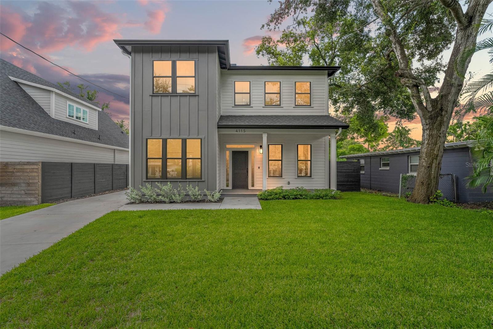 Welcome to this one-of-a-kind custom home in the heart of Seminole Heights. Newly built by the highly regarded Cottage Company, this CONTEMPORARY farmhouse style home showcases the thoughtful craftsmanship and style they’re known for. Nestled on one of the most iconic and charming streets in the neighborhood, just minutes from Downtown Tampa, Riverwalk, and Armature Works, this location gives you the best of both worlds, a peaceful neighborhood with easy access to the city. Inside, you’ll find five spacious bedrooms (three upstairs and two down), one of which is a perfect office space, and three full bathrooms. The spacious front porch welcomes you in, leading to a generous foyer and a beautifully open layout that connects the living, kitchen, and dining spaces. The kitchen was designed for serious cooks and entertainers alike, featuring a Thor gas range, KitchenAid appliances, Calcutta quartz countertops and backsplash, a pot filler, oversized island, and a walk-in butler’s pantry that doubles as a stylish bar area and is perfect to place all your kitchen appliances while not taking up counter space in your dream kitchen. Throughout the home, you’ll find standout details like 10-foot ceilings, wide plank oak-look LVP floors, built-in shelving, designer lighting, custom accent walls, and plenty of storage. Upstairs, the primary suite feels like a retreat with its cozy sitting area, oversized closets, and spa-like bath complete with marble tile, a double vanity, and a large walk-in shower. Out back, you’ve got a large yard with room to relax or entertain. The detached two-car garage features an epoxy-coated floor, and the extra-long driveway adds plenty of parking. This home is also equipped with modern upgrades like hurricane impact windows, spray foam attic insulation, and a full irrigation system. If you’re looking for a home that blends classic character with modern comfort in one of Tampa’s most vibrant neighborhoods, this one checks every box. Love the furniture too? You can even buy that and move right in to a fully furnished home!