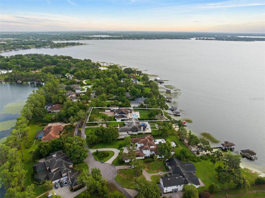 Discover 11,699 sqft of total luxury at 1455 Kelso Blvd, a stunning lakefront estate in Windermere’s Kelso on Lake Butler community. Set on nearly an acre with 119 feet of frontage on Lake Butler, this fully renovated 6-bedroom, 6.5-bath home offers over 6,448 sqft of living square footage. Features include a gourmet kitchen, first-floor primary suite with lake views, an attached in-law suite with private entrance, formal and family rooms, and multiple bonus spaces. Enjoy a saltwater pool and spa, beach, boathouse with lift, summer kitchen, and breathtaking lakefront views. Extensive upgrades include new roofing, plumbing, electrical, windows, and solar panels. A 4-car garage with EV charging and golf cart parking complete this exceptional offering. Community boat ramp access to the Butler Chain of Lakes.