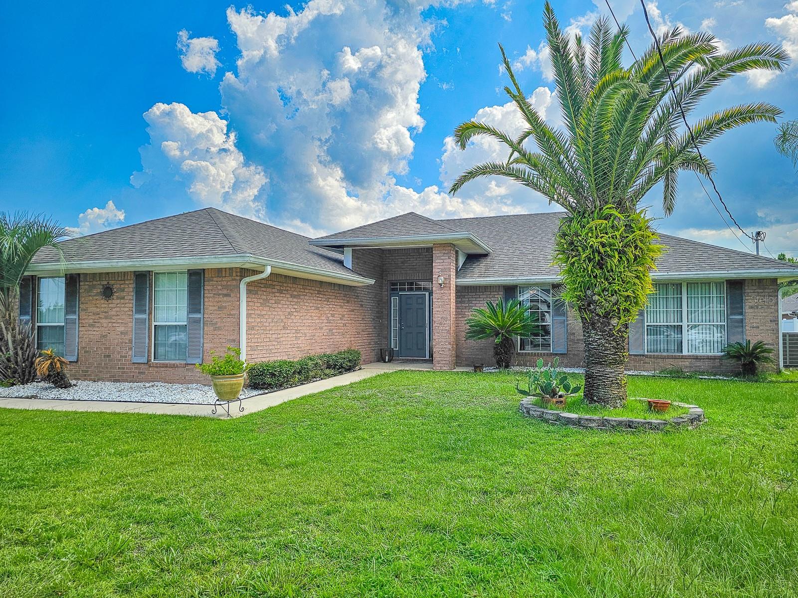 Discover this well-maintained home on a peaceful cul-de-sac in Palm Coast. Designed for comfort and maintained with care, this 4-bedroom, 2-bath brick home offers 1,804 square feet of functional living space, complete with a new roof (2021), new AC (2023), new water heater (2025), and a whole-home water filtration system. Inside, you’ll find vaulted ceilings, a split-bedroom layout, and the home showcases tile flooring throughout, ideal for coastal living. The spacious living and dining areas flow seamlessly into the screened-in lanai, perfect for relaxing or entertaining. The private primary suite features a walk-in closet and a well-appointed ensuite bath with a soaking tub, double sinks, and a separate water closet for added comfort. Additional highlights include a side-entry 2-car garage, extended driveway, irrigation system, and excellent curb appeal. Located close to schools, amenities, and just a short drive to the beaches, this move-in ready home offers both tranquility and everyday convenience. Schedule your private tour today!