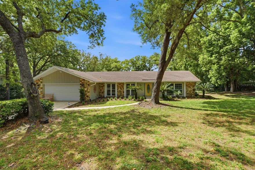 Beautifully maintained 4-bedroom, 2-bath pool home in the highly desirable Sweetwater Oaks community of Longwood. This home showcases pride of ownership throughout, starting with light-toned engineered hardwood flooring covering all living areas and bedrooms for a seamless, updated look.

The home features a formal living room with custom built-in cabinetry and shelving, complemented by large windows that frame peaceful views of the tree-lined street. A separate formal dining room with chair rail detailing provides an elegant space for hosting gatherings.

The remodeled kitchen is thoughtfully designed with white cabinetry (including glass-front accents), custom backsplash, granite countertops, stainless steel appliances, and a convenient breakfast bar. The adjacent family room impresses with vaulted ceilings, skylights, and a striking stone fireplace, creating a warm and inviting atmosphere.

A bright sunroom and breakfast nook with built-in cabinetry overlook the private backyard oasis, complete with a sparkling pool and lush landscaping—ideal for indoor-outdoor living and entertaining.

The primary suite serves as a true retreat, featuring a walk-in closet and a beautifully renovated en-suite bath with granite countertops, elevated vanities, and an oversized walk-in shower. The split floor plan offers added privacy, with three additional spacious bedrooms. The fourth bedroom includes a versatile bonus area perfect for a home office, nursery, storage, or potential third bath conversion.

Additional highlights include an indoor utility room with washer and dryer, leading to a 2-car garage equipped with a custom workshop and built-in cabinetry. Situated on just under half an acre, the property also features energy-efficient windows and a new A/C system installed in 2021.

Residents of Sweetwater Oaks enjoy exclusive access to Sweetwater Beach on Lake Brantley, to enjoy swimming, boating, fishing, a pavilion, playground, basketball court, sand volleyball, boat dock and a boat ramp. Riverbend Park provides direct access to the Wekiva River with canoe and kayak launches, along with tennis courts, sports fields, playground, hiking trails and picnic areas. The community also features a clubhouse and pickleball courts.

Zoned for top-rated Seminole County schools and conveniently located near Wekiva Springs State Park, Wekiva Island, shopping, dining, and major roadways.
 
This home offers a rare opportunity to enjoy a serene, established neighborhood with exceptional leisure amenities in one of Longwood’s premier communities. Schedule your private showing today!