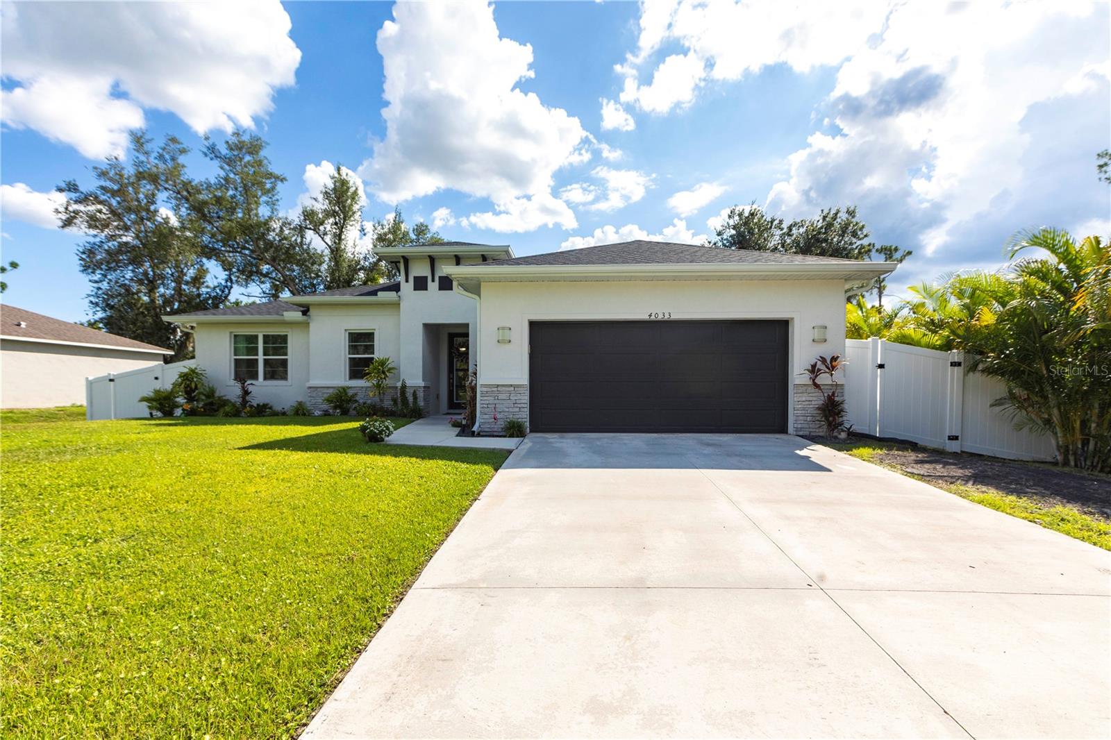 PRICE REDUCED! Welcome to this stunning, newer 3-bedroom, 2-bath modern home plus a versatile den or office, located in the heart of North Port, Florida. Built in 2022 on a spacious 10,000 sq ft lot, this energy-efficient home offers a stylish open-concept layout with ceramic tile flooring throughout, elegant tray ceilings, and beautiful finishes. The kitchen is a chef’s dream, featuring quartz countertops, a large island for prep and seating, stainless steel Energy Star appliances, soft-close cabinets, and ample storage perfect for cooking and entertaining. The home is equipped with a fully paid solar system, spray foam insulation to enhance energy efficiency, hurricane panels, and additional energy-saving upgrades, providing year-round comfort and peace of mind. Step outside to enjoy the fully fenced backyard, beautifully landscaped with plenty of space for outdoor activities, along with gutters all around the home and a convenient lawn sprinkler system. With no HOA and no CDD, this property offers freedom and flexibility. Conveniently located near I-75, shopping, dining, and parks, this turnkey gem is ready for you—schedule your private showing today!