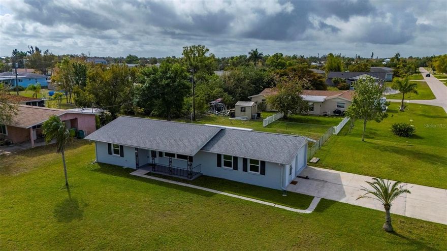 One or more photo(s) has been virtually staged. Completely Remodeled Punta Gorda Home on an Oversized Corner Lot with Workshop!
Welcome to this stunning, fully remodeled 2-bedroom, 1.5-bath home with a 1-car garage and an impressive workshop space, perfectly situated on a large fenced corner lot in the heart of Punta Gorda.
This home has been beautifully updated from top to bottom, giving buyers peace of mind with major upgrades already completed. A brand-new HVAC system with all new ductwork was installed on March 24, 2026. The home also features all new impact windows and a rear sliding glass door with built-in blinds installed in January 2025, along with new plumbing and a water heater installed in November 2024. The shingle roof was replaced in November 2022.
Step inside and immediately notice the gorgeous luxury vinyl flooring installed in 2025 that flows seamlessly throughout the home, paired with all new drywall and fresh interior and exterior paint. The kitchen is truly a standout, featuring high-end soft-close cabinets, stunning hardware, a custom green glass backsplash, and all new appliances from 2025 and beautiful bright quartz countertops.  A beautiful kitchen window fills the space with natural light, creating a bright coastal, beach-inspired feel. The bathrooms have also been updated with new vanities and toilets, and the home includes all new ceiling fans throughout.
Additional updates include the septic system and drain field fully replaced in 2017.
Outdoor living is just as impressive. Enjoy the large screened-in back lanai, perfect for relaxing or entertaining, along with an additional patio area ideal for barbecuing. The spacious fenced corner lot offers plenty of room for pets, gardening, or outdoor enjoyment.
The garage is a carpenter’s dream, offering a generous workshop area and a large walk-in storage closet in the garage for even more storage space.
Located just minutes from downtown Punta Gorda, this home provides easy access to waterfront dining, shopping, entertainment, elite golf courses, beautiful blue Florida beaches, and the new Sunseeker Resort.
This move-in ready home combines modern upgrades, functional space, and an unbeatable location—a rare find in Punta Gorda!