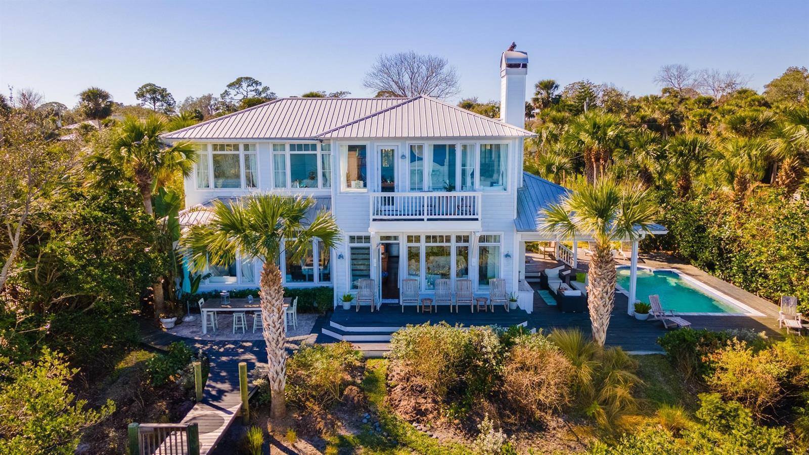This stunning, custom home is a Florida boater’s dream, boasting 100 feet of unobstructed views of the Intracoastal Waterway, teeming with wildlife. Just minutes from Ponce Inlet and a short drive from our beautiful beaches, this home offers an incredible combination of modern detail and easy-going, Old Florida charm. Bring your boats, kayaks and SUPs and enjoy world class fishing and boating in the backwaters of the lagoon. Lounge and entertain in your private, garden oasis, complete with outdoor dining, built in fireplace and a heated, salt-water pool. Perfect for large families or festive weekenders, this 4 bed/3.5 bath getaway features endless upgrades and luxurious comfort throughout. Floor to ceiling windows offer breathtaking views of the Intracoastal from every room, filling this bright, spacious home with natural light. Additional highlights include a professional chef’s kitchen, butler pantry, a 250’ private dock with boat lift and a two-story observation deck with panoramic views of the river, estuary and surrounding barrier islands. Come start your next chapter at 1001 South Riverside and discover what it truly means to live The Good Life. ;Water: City