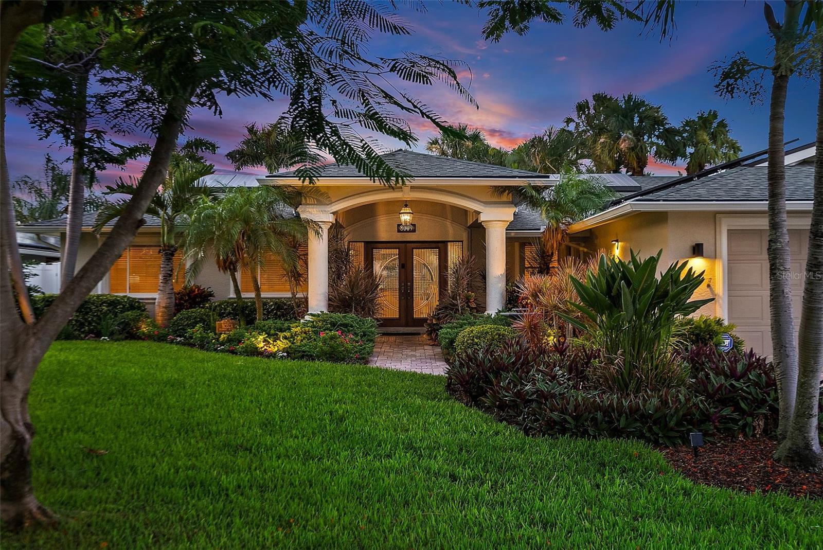 Living in Florida is all about finding your dream home where you can enjoy life with family and friends. Eureka! Here it is! This three bedroom/ three bath home, plus the office is an easy conversion to fourth bedroom. This home is located in highly desirable Yacht Club Estates and it offers a spectacular waterfront view and everything you need to entertain indoors and out. The backyard is truly a private tropical oasis. An open floor plan and living room with cathedral ceiling of cypress wood which also carries out to the enormous lanai which creates cool comfort and airiness. Cooks and non-cooks alike will love this kitchen with its subzero refrigerator, beautiful wood cabinets, and quartz countertops. The large master bedroom and spacious master bath is great as is, the master bath has the perfect spot for a soaking tub if one desires. The space and the plumbing is already right there, just needs the tub. If you work from home or just need a quiet space to relax, enjoy the nice size office with built-in double desks. Entertain by the pool (rebuilt in 2020) complete with all the bells and whistles and whip up lunch in your outdoor kitchen. Composite boat dock with 13,000 lb boatlift awaits your vessel. Another feature is a side davit for your jet ski. From a practical point of view, this home offers natural gas to the fireplace, outdoor fire, pit, stove, and the two tankless hot water heaters. 36 fully-paid-for solar panels produce enough energy to run the whole home and pool. Also included: new AC (2022), newer electrical panel, 16K natural gas full house generator, new roof (2019) and 16 x 8‘ hurricane impact 4 panel double sliding doors. Worried about flooding? This neighborhood is 12 inches higher than any other neighborhood in Pinellas county. Yacht Club Estates was voted the #1 neighborhood in Pinellas County, a very friendly neighborhood with many clubs and social events that will make you quickly feel right at home with your new set of friends. Come join us and see what Florida living is all about!