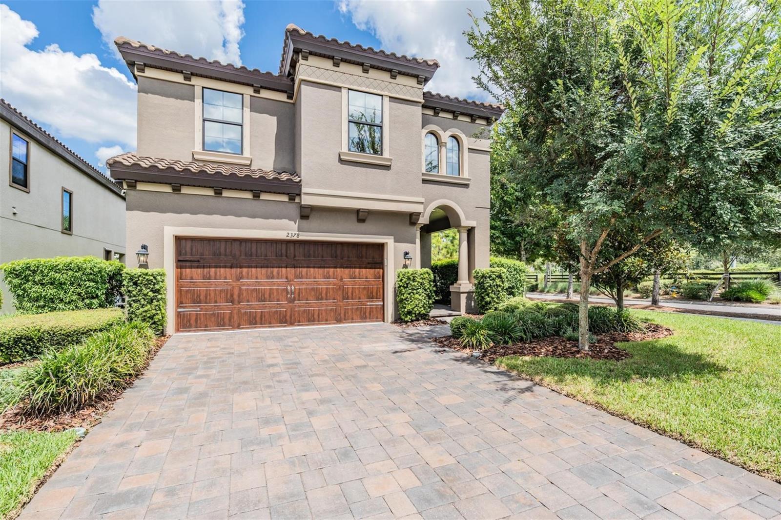 Welcome to this beautifully maintained Mediterranean style home nestled on a spacious corner lot in the heart of Starkey Ranch. Built in 2019 and thoughtfully upgraded inside and out, this 4 bedroom, 2.5 bathroom residence with a large bonus room offers the perfect blend of modern comfort, timeless design, and smart enhancements that elevate daily living. Step inside and you’ll immediately notice how natural light pours into the open-concept main living area, where the kitchen seamlessly connects to the great room and casual dining space, ideal for entertaining or simply staying connected with family. The kitchen anchors the space with its functional layout and inviting atmosphere, while the formal dining room just off the entry adds character with custom chair rail woodwork. Upstairs, the oversized primary suite stretches across the rear of the home and features a spa inspired en suite with a fully renovated walk in shower (2022), garden tub, and dual vanities. The massive walk-in closet offers ample storage and organization. Three additional bedrooms surround the upstairs bonus room, and the laundry room is conveniently located just steps from all bedrooms for everyday ease. Throughout the home, comfort enhancing upgrades abound. A premium two stage HVAC system with heat pump and Fresh-Aire AHU Series 1 UV purification system with a transferrable 10 year warranty was installed in July 2025. A whole home water filtration system and new softener were added in 2021. Window tinting upstairs (2024) and new blinds (2021) provide privacy and energy efficiency. Outside, the private backyard has been transformed into a serene retreat. Professionally landscaped with privacy shrubs along the new fence line, it also features an extended brick paver lanai with a built-in outdoor fireplace, perfect for relaxing evenings or weekend gatherings. A new irrigation system ensures easy maintenance of the vibrant greenery year-round. Located in the award-winning Starkey Ranch community, you’ll have access to miles of trails, community parks, pools, tennis courts, playgrounds, and top-rated schools, all just minutes away. Located within the award-winning master-planned Starkey Ranch community, the home sits just minutes from walking and biking trails, community parks, playgrounds, tennis courts, and stellar local schools. Nearby, Starkey Market is a charming boutique destination offering farm fresh produce, local honey, artisan goods, premium coffee, homemade ice cream, a small barn bar serving Florida craft beer and wine, food trucks, live music, seasonal events, and wide open spaces for families to gather in the fresh air. Whether you're stopping by for Sunday afternoon music, grabbing a scoop of ice cream, or stocking up on fresh-from-the-farm ingredients, it’s the vibrant community hub that makes Starkey Ranch feel like home. This exceptional home offers an unbeatable combination of upgrades, thoughtful design, and community lifestyle amenities ready for you to move in and enjoy right away. With no detail overlooked and every major system upgraded, this home delivers the move-in ready lifestyle you've been searching for.