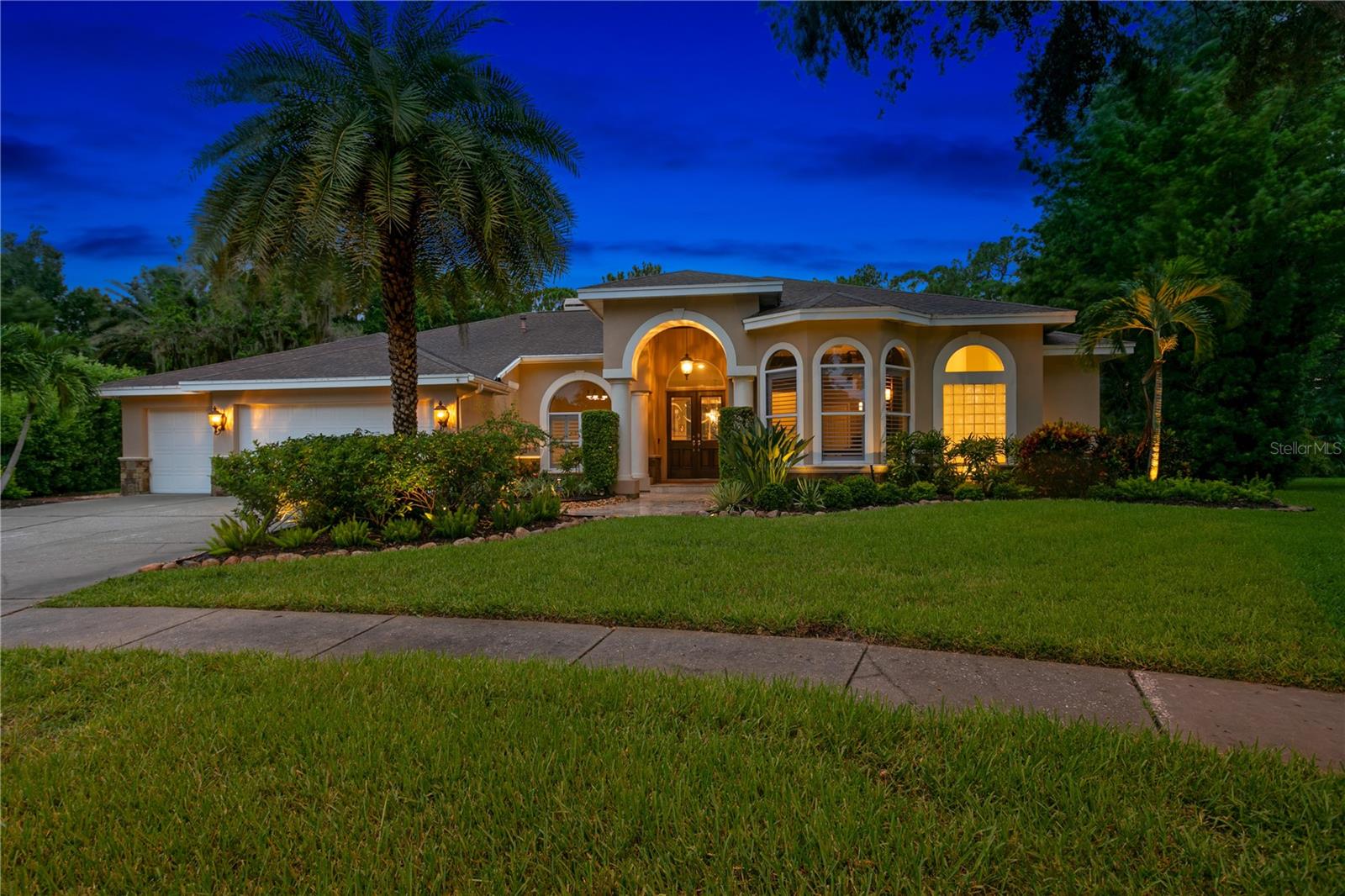 Welcome to this amazing one-acre waterfront estate on Lake Tarpon, a true haven of luxury and tranquility. This stunning property is anchored around an award-winning screened tropical pool, complete with an outdoor movie area, firepit and summer kitchen and bar - perfect for entertaining and relaxing in style. The heart of the home is an expansive open kitchen featuring built-in appliances, gas cooktop, gleaming marble counters and an expansive center island for everyone to gather. This opens seamlessly to the living room with floor to ceiling windows offering panoramic lake views and pocketing sliding doors to the inviting screened pool area –an indoor and outdoor experience. Adjacent to the kitchen, a formal dining room and a piano room provide elegant setting with additional space for gatherings and quiet moments. For those looking for a little more excitement, the large two-story family and games room with its own indoor bar area is the ideal spot for all ages to get a little noisy and have some fun and also features doors leading to an expansive patio that offers breathtaking views of the lake. With seven well-appointed and spacious bedrooms and five bathrooms, the home is designed to provide privacy and comfort for all, including an elegant ground floor primary suite with adjacent private office. The property also includes a three-car garage, a separate golf cart garage and a gym. Every living area in the home benefits from scenic lake vistas, ensuring a serene and picturesque backdrop – especially at sunset when the colors are stunning. The lush, natural foliage surrounding the grounds ensures privacy and a seamless connection to the lake. On the lake itself you'll find a private dock with seating area and a 7,000-pound boat lift providing easy access to Lake Tarpon for all kinds of water sports. As the largest freshwater lake in Pinellas County, Lake Tarpon also has a Seaplane base and so - with some minor adjustments - the dock can also be used for mooring a seaplane to allow aviators an easy arrival and departure from your Florida home. Located next to the lakefront park and within the highly regarded East Lake school district, this estate combines luxury living with unparalleled natural lakefront beauty.
