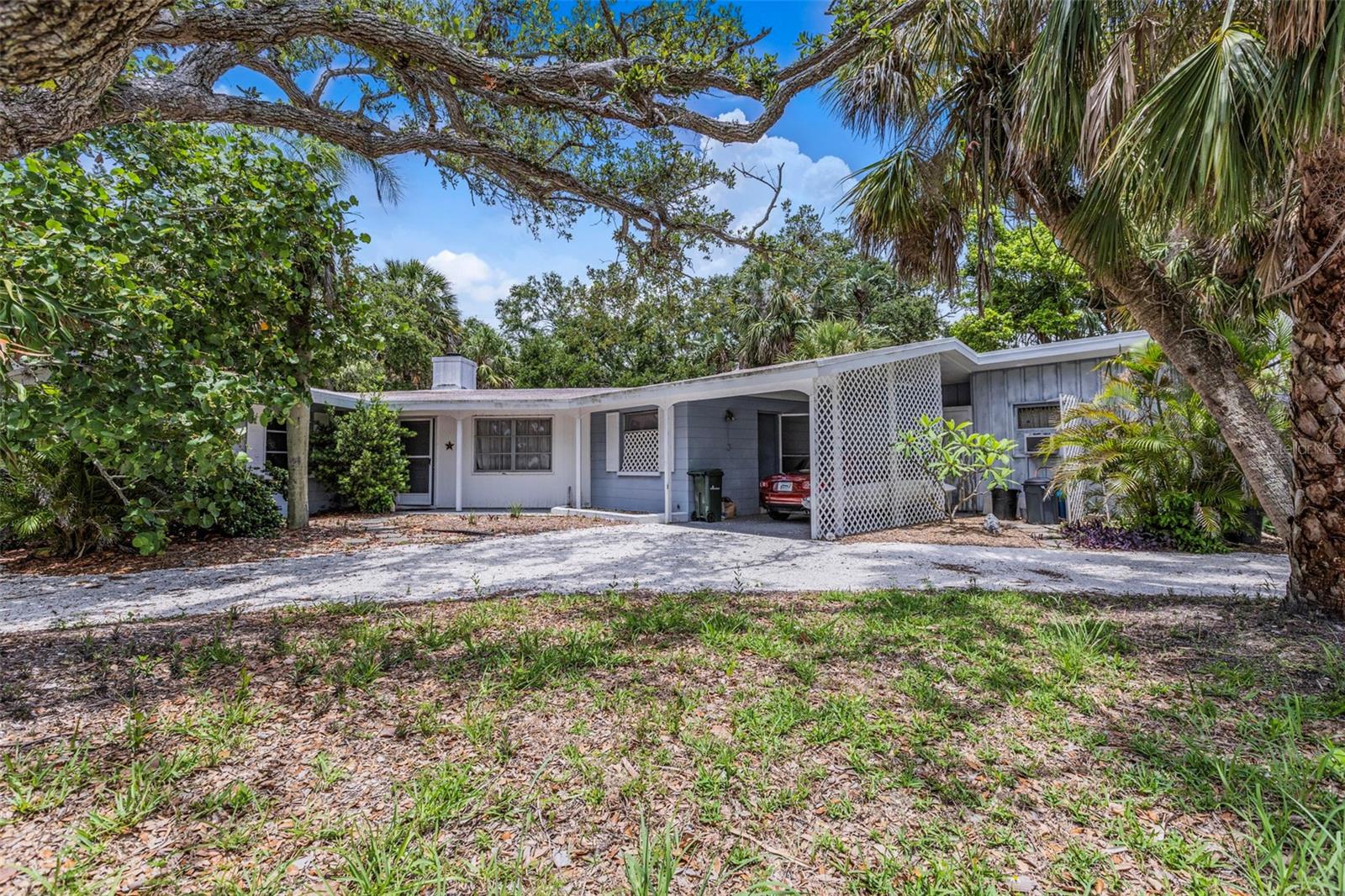 Discover a rare opportunity to own a piece of Siesta Key history with this early Ruth Richmond designed single family home, ideally situated on a spacious high and dry 12,000 sq ft lot surrounded by sea grape and mature oaks. The two bedroom two bath fixer upper includes a studio with full bath and separate entrance - perfect for guests or rental income.
Inside, enjoy a wood burning fireplace and large sliding glass doors which open to a large patio and a beautiful free form swimming pool. Kitchen is piped for gas stove. While the home needs work and has not been updated, the A/C is brand new. The home offers incredible potential to restore or reimagine.
Step outside to your private swimming pool and enjoy the serenity of a 75 foot rear barrier that backs up to Glebe Park, ensuring both privacy and natural beauty. This property did not flood in the hurricanes.
Location, character, and potential - this is your chance to create your dream retreat in one of Siesta Key's most sought-after neighborhoods.