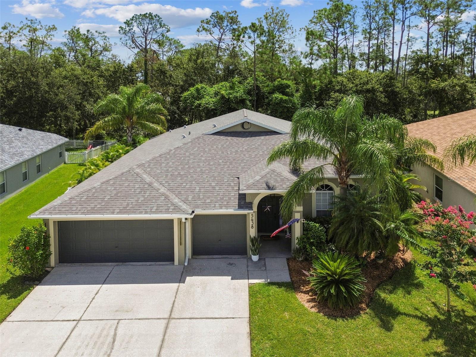 Stunning, Fully Renovated Golf Course Home – Designer Kitchen, 3-Car Garage & Private Garden Oasis! Discover this must-see home in the highly sought-after Lake Bernadette Golf Course community, where modern upgrades meet an unbeatable Wesley Chapel location. Every major update has been done—including a new roof (2023), luxury kitchen, flooring, and baths (2023), and high-efficiency AC (2019)—giving you years of worry-free living. Step inside to soaring ceilings throughout and an open, light-filled floor plan designed to impress. The custom designer kitchen is a showstopper, featuring a waterfall quartz island, high-end stainless steel appliances, rich navy cabinetry, and a striking brick backsplash—perfect for both everyday life and entertaining in style. Relax in the spacious living areas or retreat to your private backyard garden oasis, complete with lush tropical landscaping, a white vinyl fence, and a covered pergola with ceiling fan—an inviting space for morning coffee or evening gatherings. Additional highlights include a 3-car garage, resort-style community amenities (golf, tennis, and pool), and a prime Wesley Chapel location minutes from top-rated schools, shops, restaurants, and major highways. This home checks every box—location, updates, and lifestyle. Don’t wait—schedule your private showing today before it’s gone!