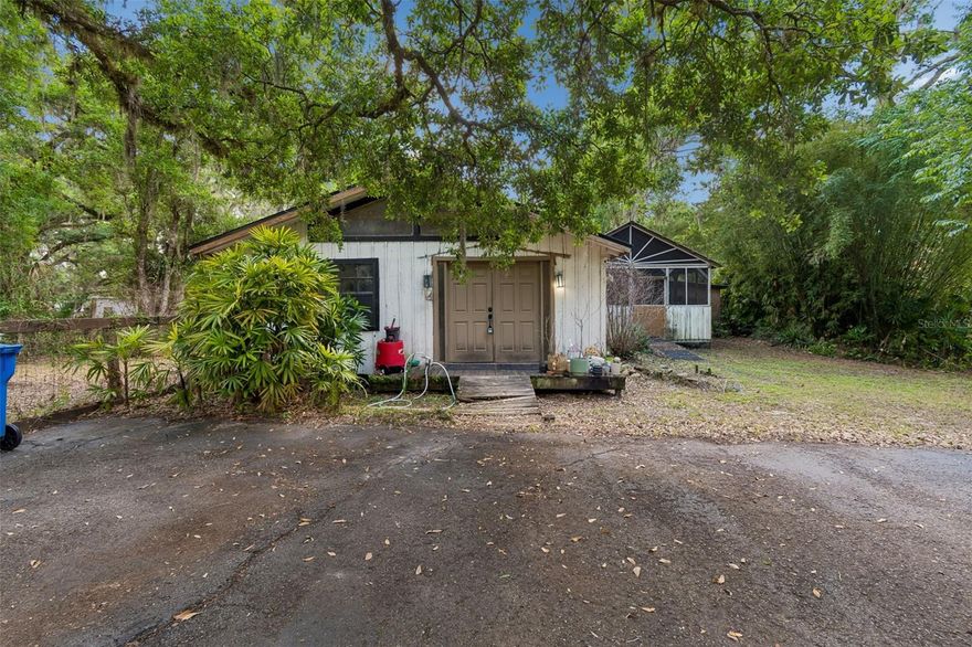 Charming 2BR/2BA cottage-style wooden cabin on a serene .32-acre lot. This one-of-a-kind property features a paved driveway, new shingle roof, and a water treatment system. Enjoy a spacious screened side porch, perfect for relaxing or entertaining. An attached storage and laundry room offers excellent functionality and presents potential for conversion into a mother-in-law or guest suite with a second bathroom attached. Inside, the home offers a warm, inviting layout with comfortable bedrooms, a fireplace in the living room, a dining room and spacious kitchen. The property provides a peaceful, private country setting while remaining conveniently close to the shopping, dining, and amenities of the New Tampa area. A rare opportunity to enjoy quiet rural living with city conveniences nearby. This property has such potential! SOLD AS-IS. It's looking for a new owner to add the final touches.  Schedule your showing today!