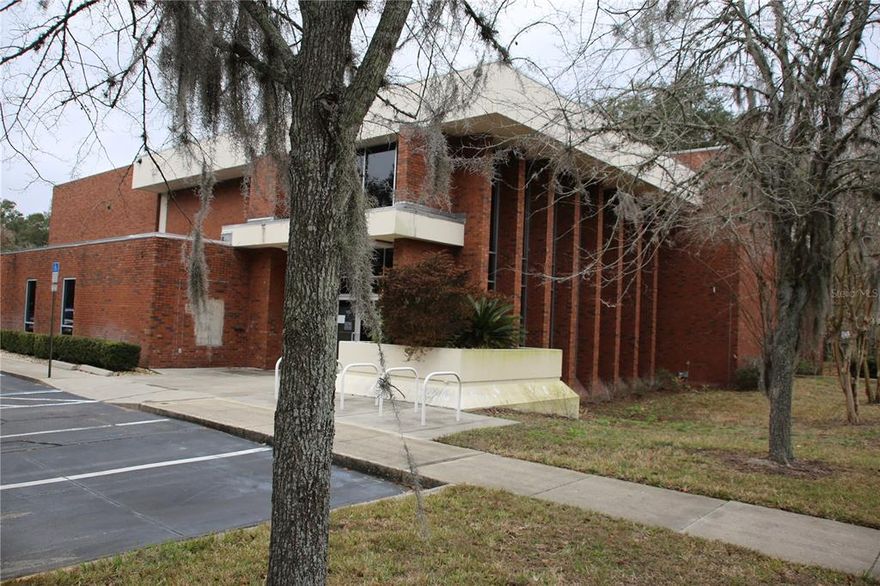 NEWBERRY ROAD!  This site is the former home of a highly successful bank absorbed by another bank with a pre-existing nearby location.  With SIX drive through lanes and a freestanding drive-through service building (which could be repurposed for multiple uses), this building offers an incredible combination of high traffic frontage, substantial drive-through access, and a spacious well-windowed floor plan perfect for a variety of uses.  The valuable frontage and visibility on W Newberry Road in the critical corridor between UF and I-75 offers an attractive option for investors and owner-occupants alike, and the flexible floor plan offers a hard-to-find combination of fifteen private offices, a spacious conference room, and open modern flex space.  This offering truly merits the attention of discriminating investors and who understand the value of exposure, traffic, and location.