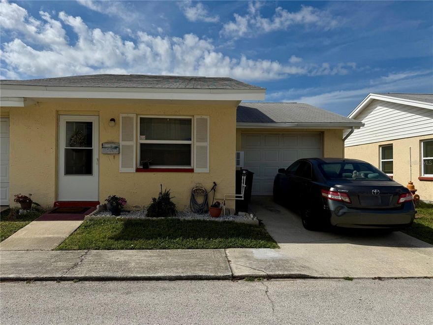 Welcome to New Port Colony, a well-maintained 55+ community in the heart of New Port Richey offering a relaxed, low-maintenance Florida lifestyle. This is the larger 2 bed 2 bath end unit.   Attached private garage parking and in-unit laundry hookups, providing everyday convenience rarely found at this price point. Residents enjoy a friendly neighborhood atmosphere with amenities including a community pool and shuffleboard courts. Available is the optional membership to the Gulf Harbors Beach Club—a private, members-only Gulf-front beach just minutes away. This exclusive beach offers soft white sand, palm-lined shoreline, and a peaceful setting ideal for swimming, sunset views, beachcombing, and relaxing without the crowds. Membership is affordable ($200/year) and provides access to a gated beach with pavilions, grills, restrooms, and a true coastal lifestyle experience that’s hard to find in this area. Conveniently located near shopping, dining, and the Gulf, this property offers an excellent opportunity for seasonal or year-round living with optional private beach access that truly sets it apart.