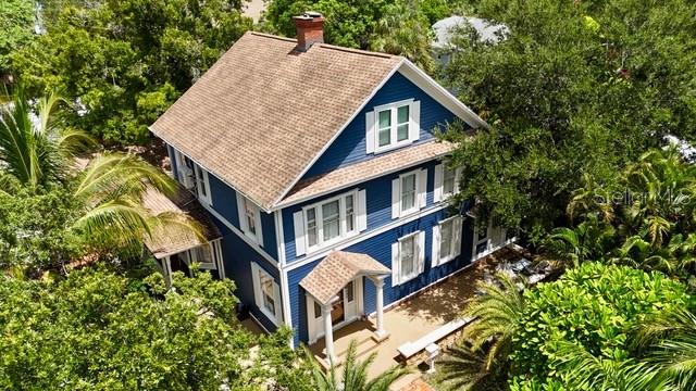Zoned T5 Up to 20 story build can be built on site! Captivating Southern Colonial home perfect for Airbnb rental. This three-story updated home built in 1900, towering century-old oaks, oversize rooms with high tin ceilings, 10-inch baseboards, an original chandelier in the foyer, arched doorways, crown molding, hardwood floors, French doors, and two double-sided marble fireplaces in between the living room and kitchen. Original wood flooring. Updated kitchen with a gas cooktop, double convection ovens, a stainless refrigerator, a stainless-steel dishwasher, and a stainless microwave. Large center island in the kitchen. Granite counter tops and solid wood cabinetry. The family room or studio is spacious, downstairs include a large foyer, den, or office, and a bright bedroom with built-ins. Upstairs, a spacious master bedroom with an updated tile floor bath. Two impeccable bedrooms and a laundry room. The remodeled loft/man cave with two walk-in closets. Two-car garage. Fire pit. Covered hot tub. New roof in 2014, tankless hot water heat, and crown molding. Updated electrical. Walking distance of historic downtown Bradenton, the River, Marina, and Riverwalk. Near the beautiful Gulf Beaches, IMG, Sarasota, and all that West Bradenton offers.