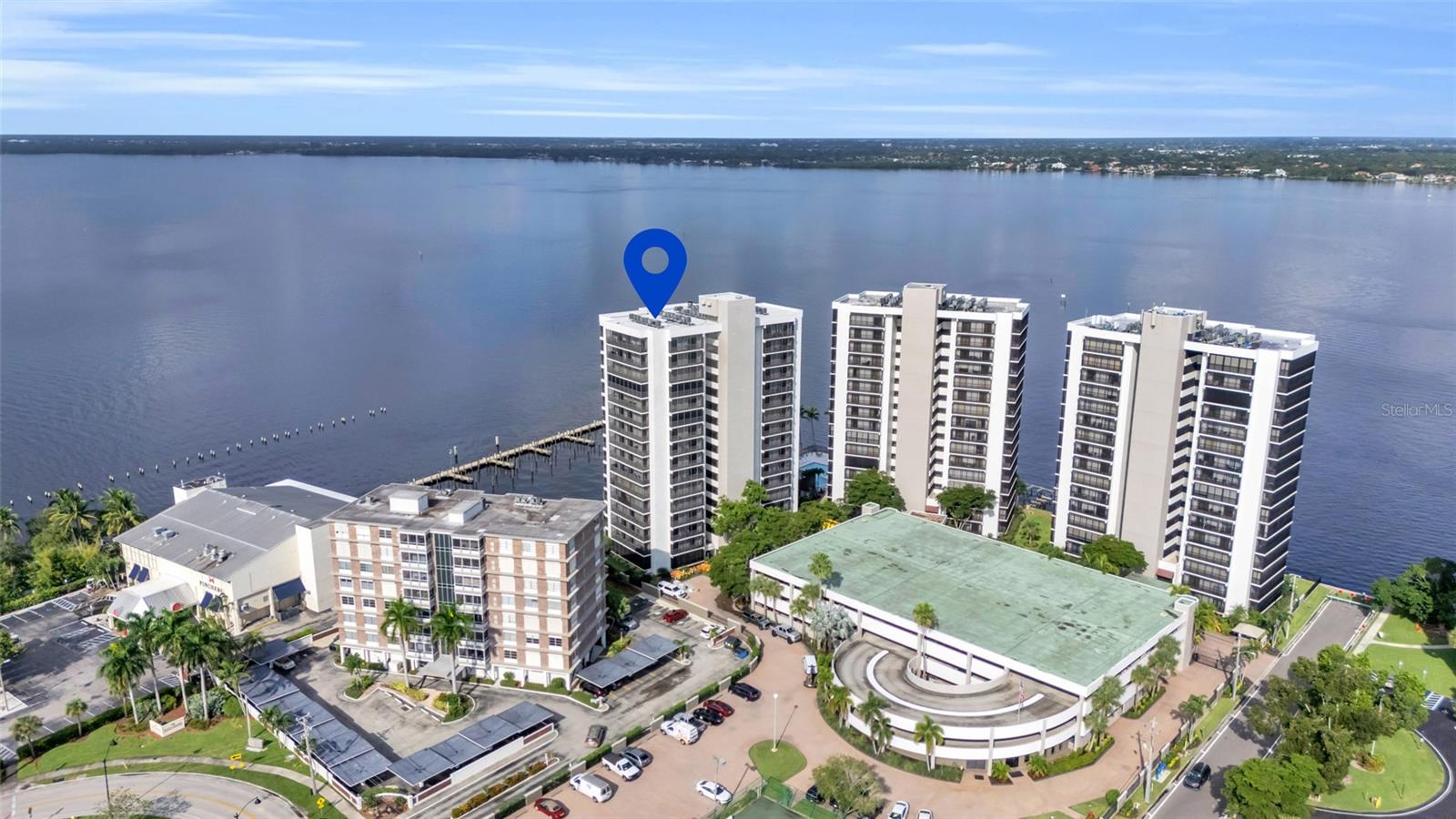 Perched on the 9th floor of one of Fort Myers’ most sought-after riverfront communities, this exceptional 4-bedroom, 3.5-bath residence offers nearly 4,000 square feet of refined living space with sweeping, unobstructed views of the Caloosahatchee River. Designed for those who appreciate both comfort and sophistication, the home has been fully reimagined with high-quality finishes, hurricane-rated windows and doors, and smart technology enhancements throughout. The condo complex is structurally sound based on new condo guidelines and no current assessments are due. The gourmet kitchen serves as the heart of the home, boasting premium appliances, custom cabinetry, and a full-service bar ideal for entertaining. Expansive living and dining areas flow seamlessly, accentuated by warm wood details and elegant flooring, creating a setting that balances openness with intimacy. The primary suite is a luxurious retreat, featuring a spa-inspired bath with a glass-enclosed shower equipped with dual shower heads and multiple jets, along with a custom-designed walk-in closet that offers extraordinary storage and style. Private balconies invite you to savor vibrant sunsets and the calming waterfront vistas, while abundant storage and thoughtful details ensure both beauty and practicality. For convenience, the property includes two first floor coveted garage parking spaces located just steps from the building entrance, as well as two private storage units. Residents enjoy peace of mind with 24-hour guarded security and an array of resort-style amenities such as a riverfront pool, fitness center, and direct access to the vibrant dining, shopping, and cultural experiences of downtown Fort Myers. Combining unmatched square footage, timeless elegance, and panoramic views, this residence presents a rare opportunity to own one of the finest homes along the riverfront.