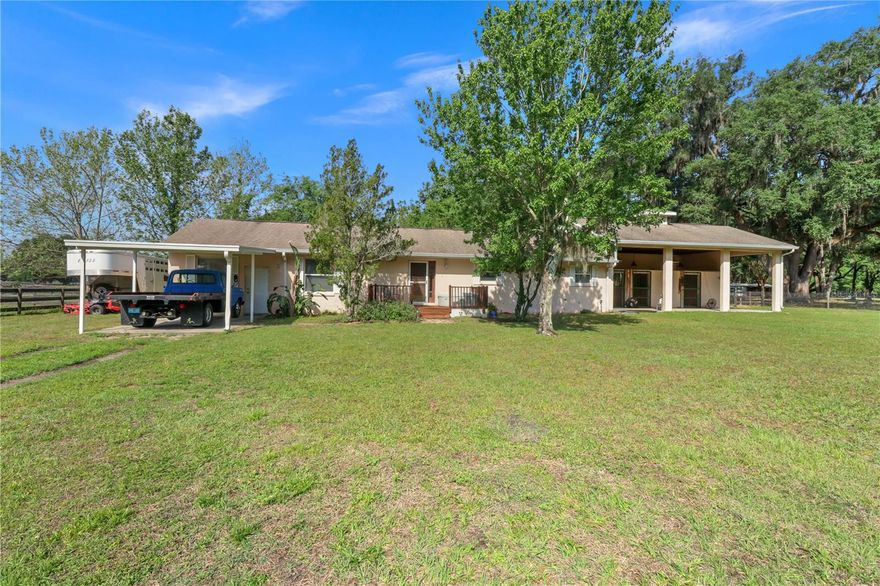 Price Improvement! Absolutely move-in ready and clean as a whittle. 
If you ever wished you could share space with your most loved 4-legged, equine friends then here is your chance. Beautiful park-like setting on this 5 acre equestrian paradise. 
All the things you would want and expect on a large scale farm, we have in a cozy and manageable 5 acre setting for you. Three stall, concrete block construction, barn attached to the house making it convenient to check on your horses without ever leaving your covered aisle way with cement floor.
Each stall has a run behind the stalls leading to the pastures. Metal rolling doors for entrance and a double door on the back of each stall. Open the top just for some cross breeze or top and bottom for access to the paddock. Fenced and cross fenced with three board creosote boards and no climb wire for three separate pastures. Separate aisle in between pastures. Gorgeous grandfather oaks for amazing shade. Wash rack with hot and cold water. Additional barn for hay/feed, and a 60 foot round pen. If you love your horses as much as we do, that was the most important part right?  Now wait till you see the house. Huge, open floor plan with natural light pouring in from every direction. The kitchen has all new stainless steel appliances and gorgeous new granite counter tops. The bathrooms were also recently topped off with new granite as well as new faucets. Giant screened porch perfect for morning coffee or watching the farm for a relaxing evening. Very easy to show but by appointment only. Your next homestead is waiting for you and your favorite farm friends are welcomed too. Chickens, pups, goats they can all come. No HOA or deed restrictions. All high and dry, no flood insurance required. Conveniently located just minutes from the great town of Bushnell but tucked away down a private lime-rock drive   They say you can have it all….and we think this is it. Call today.