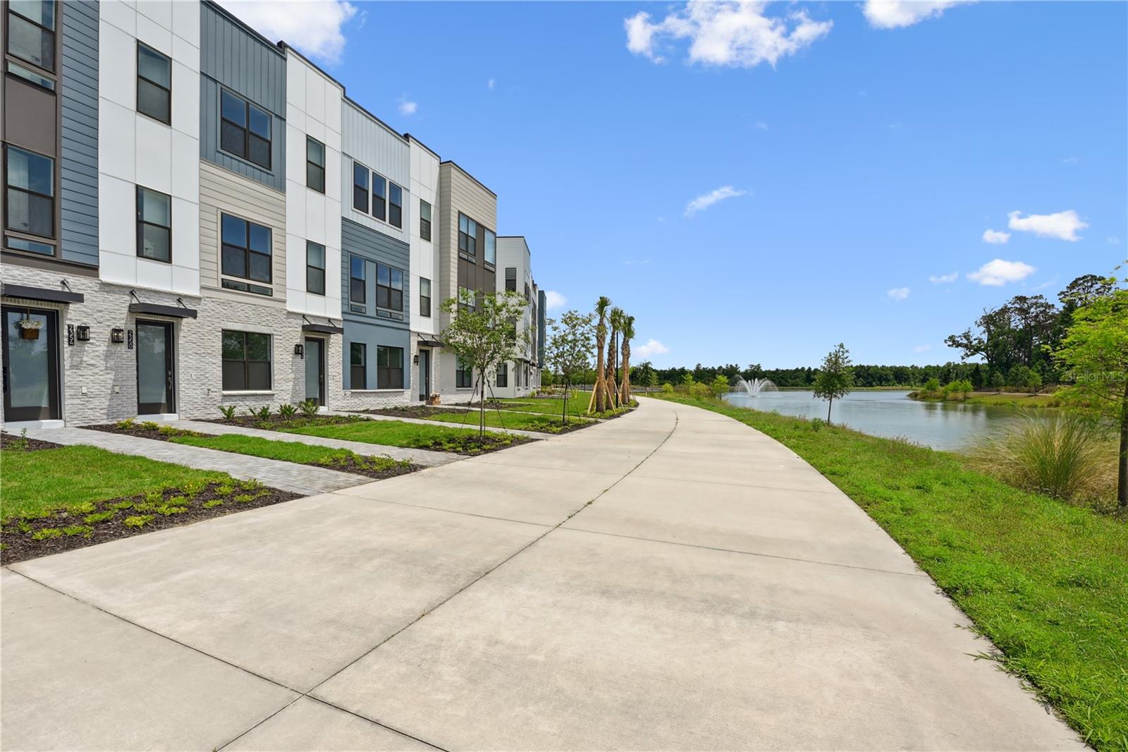 Looking for a quick move-in opportunity? This stunning 2-bedroom, 3.5-bath townhome offers 1,449 sq. ft. of modern living space, a 1-car garage, and a private rooftop terrace with waterfront views. The rooftop comes fully equipped with connections for a summer kitchen, fireplace, hot tub, hose bib for gardening, and durable Trex decking - perfect for entertaining or relaxing under the stars. Located in The Brix, a boutique townhome community in Orlando’s highly sought-after Packing District, this home puts you steps from a vibrant lifestyle. Enjoy access to the 1.5-mile walking and biking trail, the new YMCA, City of Orlando Tennis Center, amphitheater, and walkable favorites like the food hall, Publix, Foxtail Coffee, a rock climbing facility, and Hotworx studio. With limited residential opportunities remaining, now’s the time to take advantage and purchase your Townhome at The Brix!