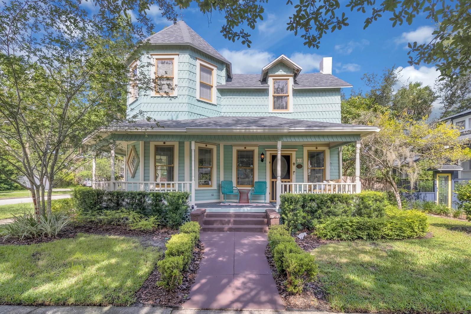 Every once in a while, a home comes along that truly stops you in your tracks—and this is it! This is your chance to own one of Sanford’s most iconic homes! Known lovingly by locals as the Alligator Inn, this 1900 Queen Anne-style gem is not only rich in character, but also rich in story. Featured three times as a Porchfest host and proudly listed on the National Register of Historic Places, this unforgettable corner-lot home sits on one of the most picturesque blocks in Sanford’s beloved historic district.
From the moment you arrive, the wraparound porch sweeps you off your feet. With an idyllic porch swing that practically begs you to slow down and stay awhile, this is the perfect spot for morning coffee, evening cocktails, or long conversations with friends that last well past sunset.
Step into the backyard retreat, and you’ll find just as much charm. The mix of artificial turf, paver patio, and spacious deck gives you versatile outdoor living year-round. And don’t forget the mango tree, offering up plenty of fresh, juicy fruit every summer—mango salsa or mango margaritas, anyone?
Inside, this bright and cheerful home boasts hardwood floors throughout, a cozy living room with a fireplace, a fully remodeled kitchen (2018) with timeless white cabinetry, granite countertops, and stainless steel appliances, plus a full bath downstairs and a home office with a convenient half bath. Upstairs, you’ll find three more bedrooms and another remodeled bathroom (2022).
One major bonus? The home was just professionally tented for termites, so you can move in with peace of mind knowing that big-ticket item is already taken care of. Even better—the home was painted in 2021 and the roof (2021), gas tankless water heater (2018) and AC (3 zones upstairs and a special ionizer) are all newer, giving you even more confidence in the home’s upkeep and long-term value.
And there’s more: the detached 2-car garage (expertly constructed in 2013 with permits) includes an upstairs bonus room that could easily become a private apartment, studio, gym, or hobby space. Tons of storage and parking (even off street outside) for your cars, golf cart, or weekend toys make it practical as well as charming.
If you’ve been watching this one, now’s your chance—homes like this don’t come up often. In fact, it hasn’t been available in almost 20 years.
Living in Sanford: A Slice of Small-Town America
Downtown Sanford isn’t Central Florida’s best-kept secret anymore—because the secret’s out. People are discovering what locals have known all along: Sanford is where charm meets community. Picture quiet weekday mornings strolling past historic homes, biking around Lake Monroe at sunset, or hopping in your golf cart for dinner, a brewery tour, or a bit of downtown thrifting.
This is a walkable, bikeable, lovable lifestyle—where neighbors become friends, and the porch is as important as the living room. Whether it’s Sunday Funday, live music at a local pub, or catching the free shuttle to SunRail for a car-free trip to Winter Park or Orlando, Sanford offers the kind of connected, low-key, joyful living that’s hard to find elsewhere.
Plus, with easy access to 417 and I-4 and top-rated Seminole County schools, this charming town delivers both convenience and quality of life. And perhaps best of all? The people. Sanford is a true community, where friendly faces, local pride, and a shared love of small-town living bring everything to life.