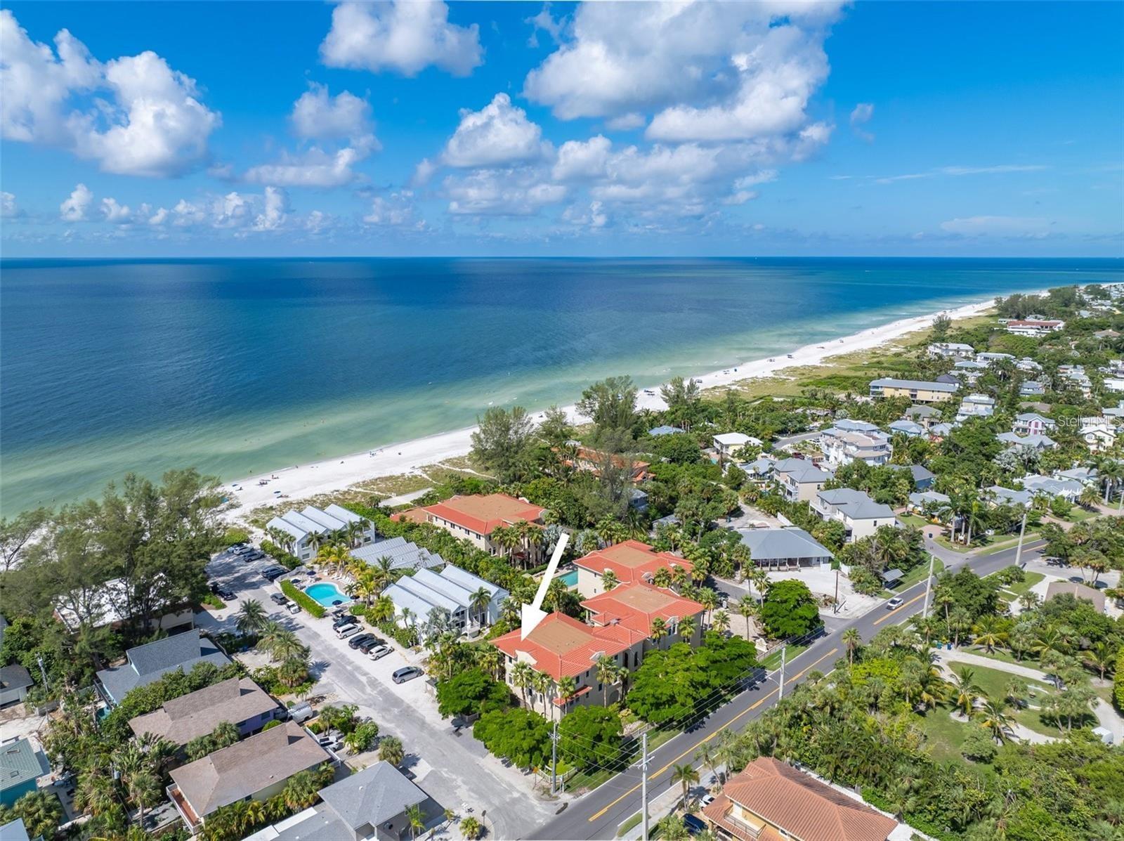 RARE AND FABULOUS GULF FRONT 3B/2.5B LUXURY CONDO AT LA CASA COSTIERA W/ 2300 SQ. FT. La Casa Costiera allows for weekly rentals and has EVERYTHING you could want for in a beach condo on Anna Maria Island! 3RD LEVEL END UNIT with partial Gulf of Mexico views, semi-private ELEVATOR comes to your front door, TURN KEY FURNISHED, 2 car covered secure and reserved garage parking spaces, beach storage closet, private beach access, heated pool, an in-ground spa, a picnic area with a gas grill, a charcoal grill, outdoor fireplace and owners are allowed to have 2 large pets! The condominium built in 2005 by Brent Whitehead Construction has a beautiful exterior that fuses Italian Tuscan and Spanish Mediterranean style on the powdery-white sands of the Gulf of Mexico. This spacious, light-filled condominium has an elegant owner's suite with grand entry, plus two other very generously sized and appointed guest rooms. The wet bar with wine cooler and the electric fireplace along with the high ceilings complete with crown moldings and Andersen Impact doors and windows with custom window treatments and plantation shutters adds to the wonderful luxury beachfront atmosphere. Sliders open to Gulf breezes on the large balcony with beach views and perfect for dining or relaxing. Amazing Holmes Beach location, and the free AMI trolley stops out front! Whether you're looking for a vacation home, an investment property, or a place to call your own, this Condo offers a perfect blend of luxury, comfort and convenience.
