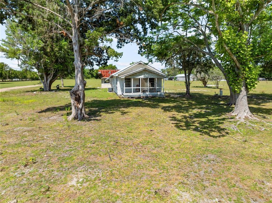 Investor special with endless potential! Situated on 3.8 acres of cleared land with some beautiful old shade trees, this 1947 wooden farmhouse offers a rare opportunity to create something truly special. The existing home features 3 bedrooms and 1 bathroom and is ready for a full renovation to bring it back to life. A detached 2 car block garage adds additional value and functionality. Whether you're looking to build your dream home (there is a impact fee credit on this one), explore the possibility of splitting the property for multiple homesites or renovate the existing structure the options here are wide open. With plenty of usable land this property is a blank canvas for your vision. No HOA and you can bring the horses, goats,chickens and outdoor toys as well! Conveniently located near shopping, restaurants, schools and with nearby access to the Florida Turnpike this property combines country space with everyday convenience. Opportunities like this don't come along often bring your ideas and make it your own!