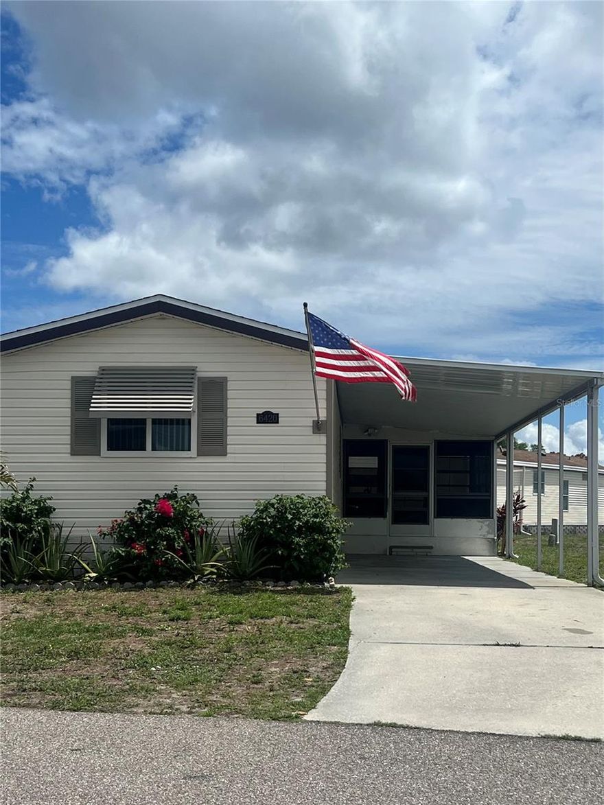 Holiday Park is a 55+ Community where you OWN the land! Nothing to do here at 6420 Haele Court but move right in to this spacious 3 bedroom 2 bath, tastefully furnished inside and out. This home is a very well maintained and updated 1988 beauty!! Pride of ownership shows up in all the attention to details. Strong 1/2" plywood wrapped in vinyl siding, hurricane windows, new architectural shingle roof in 2022, flooring not only has newer waterproof laminate throughout the home but the majority of the home also has been updated to a 3/4" plywood sub-flooring plus new insulation and also a sub-floor vapor barrier was installed in 2026 in the majority of the home. Both bathrooms have had a make over with new shower stalls, sink and cabinetry. Stunning kitchen was remodeled in 2022 with stainless appliances, lovely cabinetry and fabulous farm sink!
In Holiday Park you own the land with a deed, and your $195.00 monthly maintenance fee ($2340.00 a year) is included in your taxes. The community features 2 clubhouses, 2 swimming pools, a library, a fitness room, tennis courts, pickleball & bocce courts, to name a few. You are close to shopping, dining, entertainment, numerous golf courses, sports facilities, and SW Florida's renowned beaches. Come take a look!