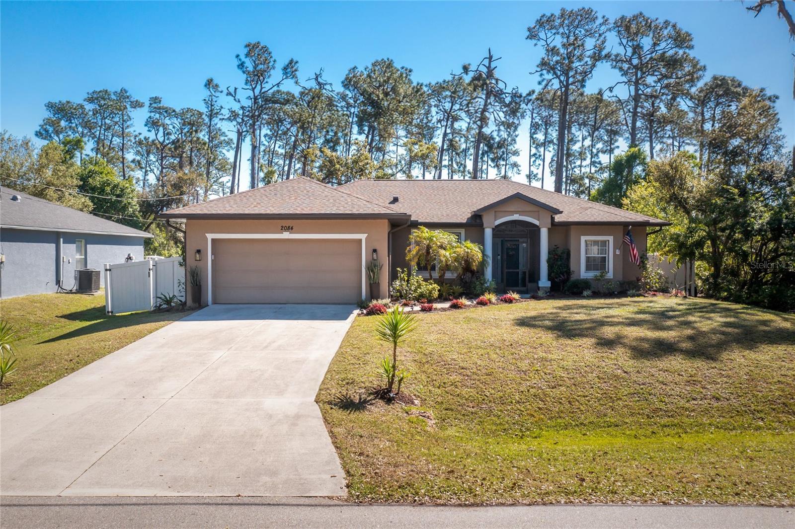 This is the one all the agents LOVE to show! Nestled on a quiet street in a charming neighborhood, this exquisite residence offers the perfect blend of comfort and style. You will be greeted by low-maintenance landscaping and a welcoming screened front porch that sets the tone for the beauty found within. Step inside to find a thoughtfully designed split floor plan with an open-concept layout, high ceilings and natural light galore. Home features 3-bedrooms plus bonus room in case you need a 4th, 2 bathrooms and an oversized 2 car garage. Open kitchen offers dual pantries, granite countertops, stainless steel appliances, eating area, an expansive breakfast bar overlooking the family room and a wall of retractable sliders that open seamlessly to the screened pool area, blending indoor and outdoor living perfect for entertaining. The versatile bonus room can serve as a private office, playroom, hobby space, or guest room. The private master suite is a peaceful oasis, offering another set of retractable sliders with unobstructed nature views and direct access to the pool. The spacious walk-in closet with built-in shelving maximizes storage, while a separate linen closet adds even more storage. The en-suite bathroom is designed for ultimate relaxation, with a dual-sink vanity, a large soaking tub and separate shower. New black matte hardware and lighting create a spa like experience. On the opposite side of the home, two more spacious bedrooms share a well-appointed guest bath with a tub/shower combo. A separate indoor laundry room features custom cabinetry for extra storage. Washer and dryer are included. Outside, enjoy Florida living year round in your salt water pool with new 2023 heater. The expansive screened deck spans the entire length of the home, offering a covered lanai with serene views of butterflies, birds, and lush landscaping. Buy now to enjoy fresh mangos next June! Other notable features include NO CARPET! Ceramic tile throughout except for luxury vinyl tile in bedrooms, oversized garage with abundant storage, cabinets and work bench. Outdoor storage shed. Roof, soffits and all-around Leaf- filter gutters were replaced in 2023. Fully fenced yard. Privately owned undeveloped lots behind and to the side provide extra peace and quiet. This home is truly move-in ready and offers peace of mind for any situation. No HOA to contend with. Sits high and dry in no flood zone. ADT security system. Transfer switch and included generator provides power to entire home during outages. The septic tank has just been replaced and passed inspection. Courtesy of seller 1-year prepaid Choice Home Warranty transfers with home. With the total plan relax knowing that all appliances, AC, plumbing, electric, garage door opener, water heater, well pump, septic system, septic tank pumping and pool equipment are covered. Did we mention the ASSUMABLE VA LOAN WITH SUPER LOW 2.99% INTEREST RATE? What are you waiting for? Come see this home centrally located in the heart of North Port. Easy access to I-75 and Tamiami Trail. Just minutes to shopping, schools, restaurants, sports facilities, numerous golf courses and world-class SW Florida beaches. This is a must see!