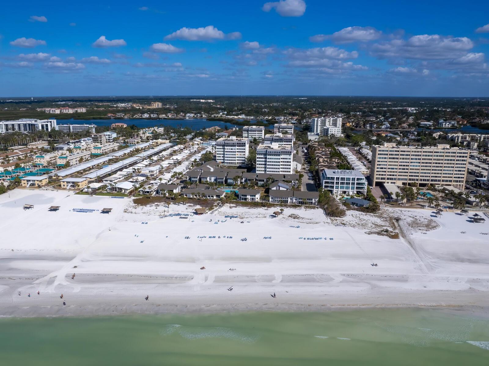 New Price – Exceptional Beachfront Living in the Heart of Siesta Key.
Experience the essence of coastal luxury in this beautifully appointed 5th-floor residence with commanding views of Siesta Beach, the Gulf of Mexico, and golden sunset skies. Perfectly positioned within the highly desirable Peppertree Gulf-to-Bay community, this spacious two-bedroom, two-bath condominium offers a rare opportunity to own a slice of paradise.
Timeless Spanish-inspired architecture sets the tone, with coffered beam ceilings, graceful arched doorways, and elegant finishes throughout. Walls of windows frame breathtaking Gulf views, flooding the open-concept living and dining spaces with natural light and coastal ambiance.
The thoughtfully designed kitchen features custom wood cabinetry, gleaming granite countertops, stainless steel appliances, and a charming built-in breakfast nook—ideal for casual dining with a view. Retreat to the generous primary suite, complete with a walk-in closet and a luxurious en-suite bath featuring granite-topped vanities and custom cabinetry. A well-appointed guest bedroom and full bath with walk-in shower ensure comfort and privacy for visitors.
Step onto the expansive, enclosed lanai—a multifunctional space that offers the perfect setting for entertaining, working remotely, or hosting overnight guests—all while enjoying spectacular beach and Gulf vistas.
Sold fully furnished, this turnkey residence includes a large laundry room with abundant storage, a full-sized washer and dryer, a private parking space in the under-building garage, and a secure storage locker for all your beach essentials.
Residents of Peppertree Bay enjoy an array of resort-style amenities including a private beach with lounge chairs, two heated swimming pools, fitness center, saunas, tennis and pickleball courts, barbecue grills, a fishing pier, and on-site management. Just a short stroll from Siesta Village's shops and dining, and a quick drive to Sarasota’s cultural attractions, this is coastal living at its finest.
Whether you’re looking for a full-time residence, winter retreat, or investment with rental income potential, this exceptional beachfront property checks every box. Don’t miss your chance to own the Siesta Key lifestyle—where every day feels like a vacation.