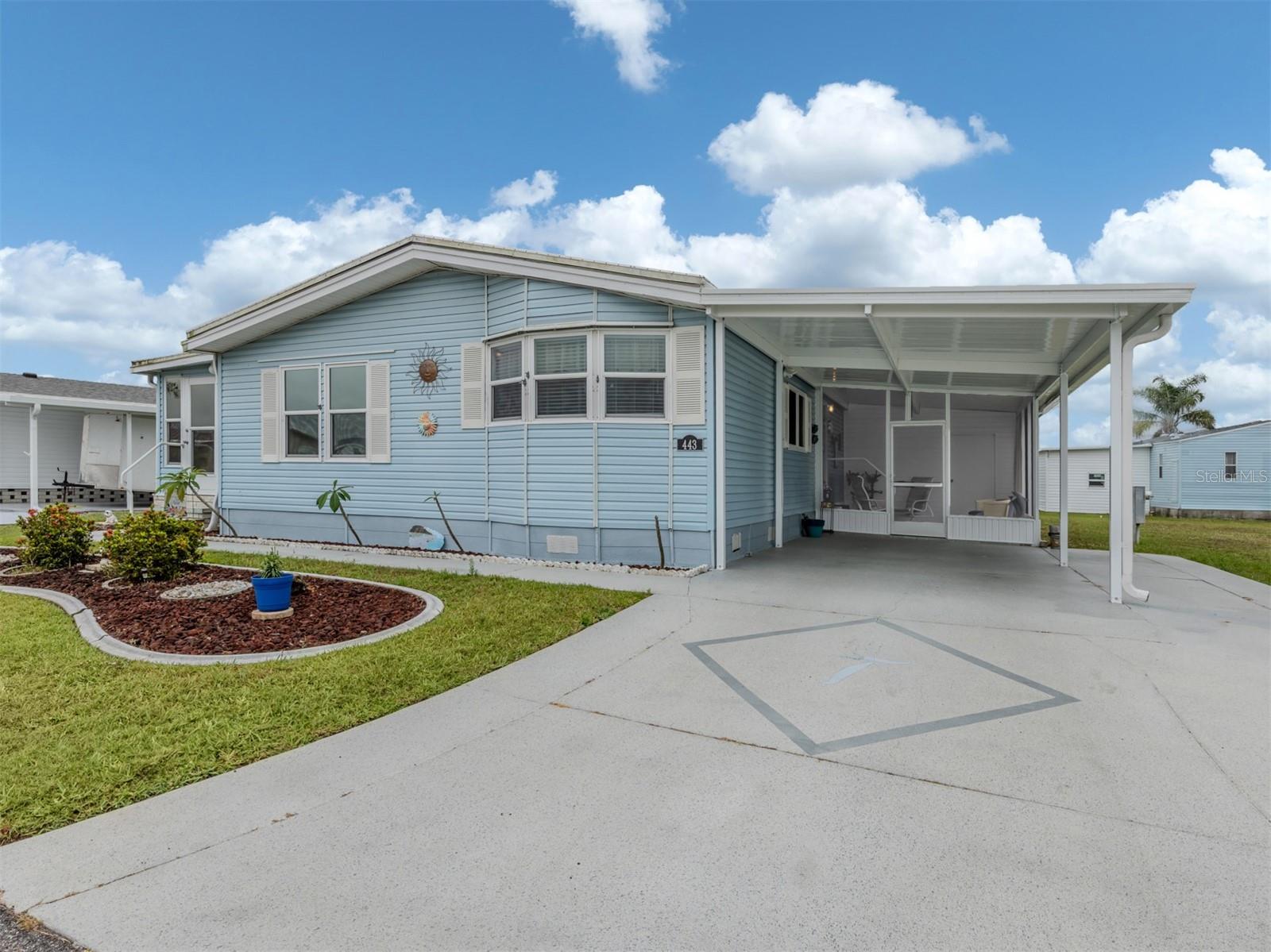 Welcome to this lovely and impeccably maintained 2 bedroom, 2 bath manufactured home located in the highly desirable, land-owned and pet-friendly community of Harbor Isles. Situated just across from the lake, this charming residence offers a light and bright interior with vaulted ceilings and new luxury vinyl flooring throughout. The cheerful kitchen features cream-colored cabinetry, a tile backsplash, and windows with lake views, creating a warm and inviting space for everyday living.
An expansive Florida Room with glass windows and a dedicated window AC unit runs the full length of the home, providing the perfect spot to relax, entertain, or enjoy the serene surroundings. The updated windows (2013) throughout the home allow for plenty of natural light, while built-ins add convenient extra storage. The inside laundry room is another practical bonus.
The spacious master suite includes an ensuite bath with a walk-in Jacuzzi tub, perfect for relaxing at the end of the day. The guest bedroom also features built-ins and sliding doors that open to the Florida Room, giving guests their own private retreat.
Recent updates include a new roof (2023), AC (2017), new carport, shed, and a screened lanai—all oriented to enjoy the peaceful lake views just across the street. This home truly has it all and is move-in ready for full-time or seasonal living.
Harbor Isles is a premier 55+ community nestled along the shores of the Myakka River. Residents enjoy a wide array of resort-style amenities, including a heated pool and spa, clubhouse with fitness center, tennis and pickleball courts, bocce ball, shuffleboard, and a marina with boat slips and a kayak launch. Social activities and clubs make it easy to connect with neighbors and enjoy the Florida lifestyle. Best of all, you own your land, and the low HOA fees make Harbor Isles an incredible value.
Don't miss your chance to live in this vibrant, waterfront community—schedule your private showing today!