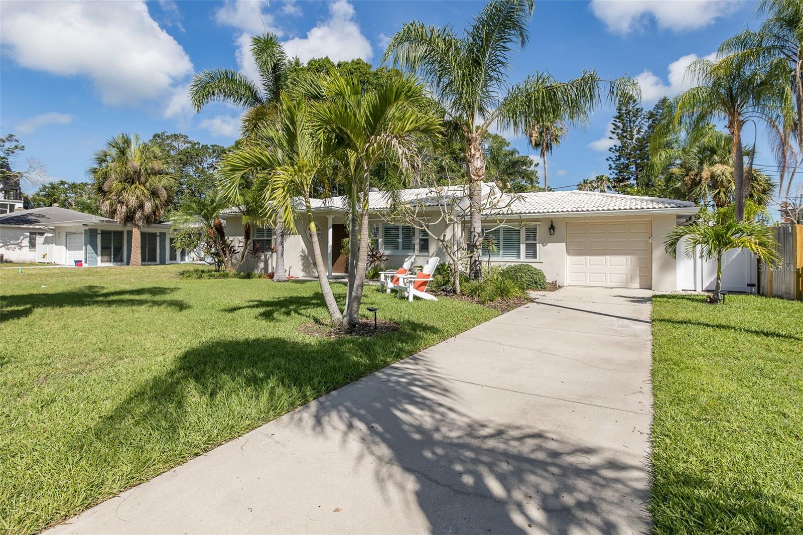 Welcome to this unbelievably charming and beautifully remodeled home, perfectly situated on a majestic brick street in historic Dunedin! This warm and cozy 2-bedroom, 2-bath residence blends classic character with modern updates — all within walking distance to four waterfront parks and the renowned Pinellas Trail.
Every detail has been thoughtfully upgraded. Enjoy peace of mind with a brand-new AC system (2025), new electrical panel with marine-grade wiring, new overhead plumbing, and a new garage door. The stunning kitchen features KitchenAid stainless steel appliances, bright and cheerful stone countertops, soft-close drawers, and all-new cabinetry.
Step inside to find fresh, rich paint tones inside and out, new Mohawk luxury vinyl plank flooring throughout, all-new doors, and newly installed plantation shutters (June 2025) paired with newer windows for abundant natural light. Both spa-like bathrooms showcase stylish new vanities, creating a serene retreat.
The spacious living room is filled with light from a lovely picture window, while the dining room offers ample space for gatherings. The oversized screened and tiled back porch may just become your favorite spot — perfect for relaxing while overlooking the private, fenced backyard brimming with tropical plants. There’s plenty of room for grilling, games, or an evening bonfire. Enjoy the convenience of an outdoor shower after gardening, a beach trip, or kayaking.
Speaking of adventure — launch your kayak just two blocks away, or hop on the trail and explore downtown Dunedin’s vibrant restaurants, breweries, shops, arts center, community center, marina, and more. And don’t forget, the world-famous Caladesi and Honeymoon Islands are just minutes away.
Don’t miss this chance to live the dream lifestyle in one of Florida’s most desirable communities — schedule your showing today!