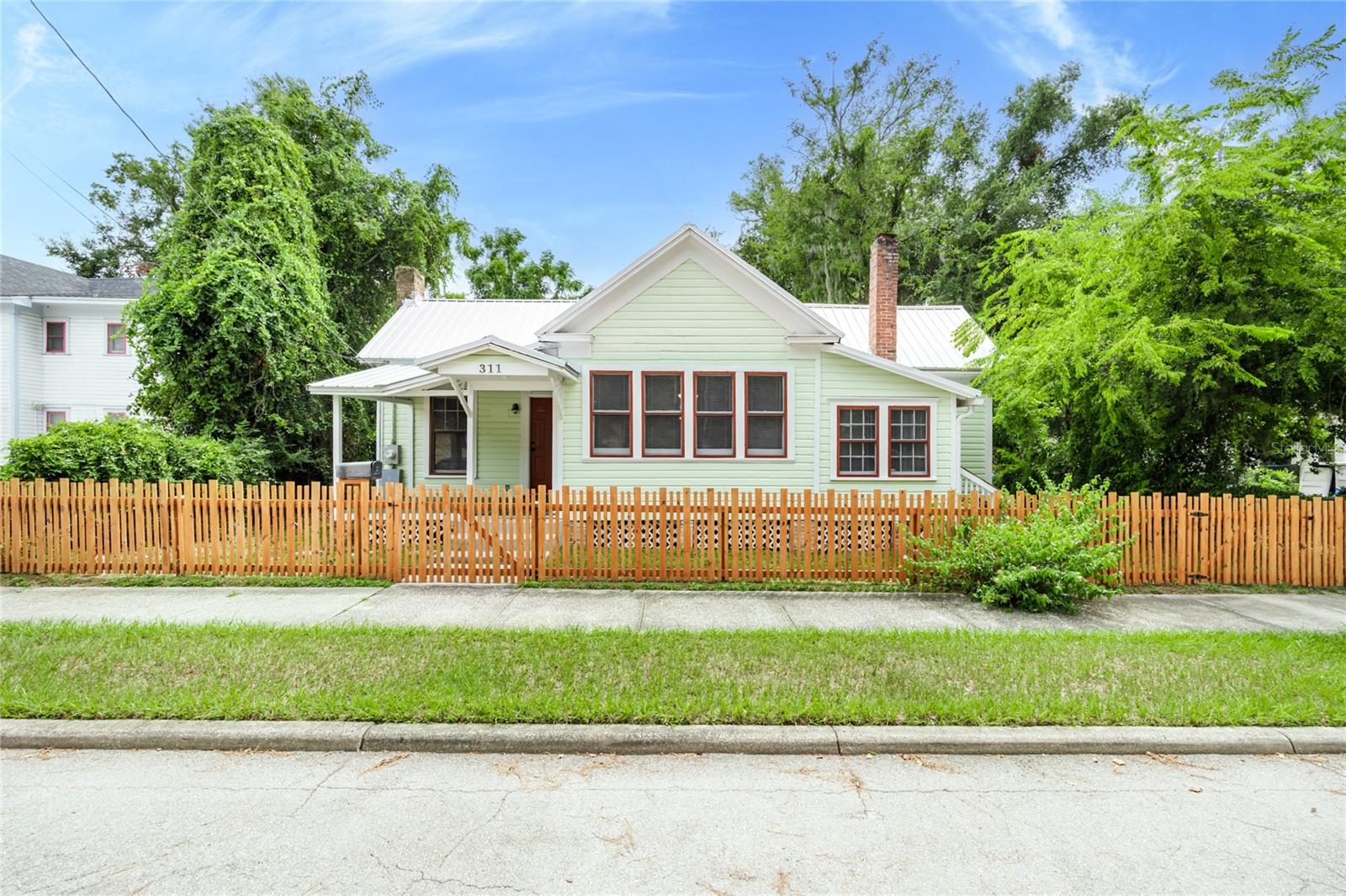 This property offers an unbeatable location close to downtown, with quick access to the business district, restaurants, shopping, and everything else the area has to offer. It’s versatile too—perfect as a home, an office, or even a mix of both. Inside, you’ll find a spacious living or great room, giving you plenty of flexibility for how you want to use the space.Enjoy relaxing on the inviting front porch or step out back to a great covered porch that overlooks a large backyard. The home features a durable metal roof, plus a wood fence along the front for added character. Whether you’re looking for a comfortable residence, a convenient office setup, or a combination of the two, this property fits the bill.