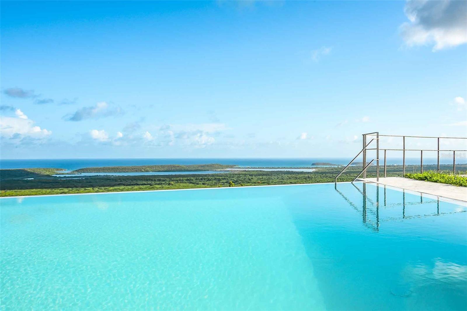 Casa Viento Norte on Vieques Island offers a luxurious Caribbean lifestyle. Imagine waking up to the Caribbean sun through floor-to-ceiling glass doors, with the scent of fresh coffee from your state-of-the-art kitchen. Located in the sought-after Los Chivos neighborhood, this property is more than just a home; it’s your dream Caribbean retreat.
Designed by renowned architect Carlos Fierro, this contemporary tropical home features a polished concrete plaster finish, blending modern aesthetics with earthy appeal. Situated on one of the highest points of Vieques, Casa Viento Norte offers unobstructed views of both the north and south coasts. From the comfort of your home, gaze at the shimmering Caribbean Sea, the lush terrain towards Mount Pirata, and even catch a glimpse of El Yunque rainforest on the Puerto Rican mainland.
Casa Viento Norte embraces its natural surroundings while offering modern luxury. The house is fully furnished with custom-made pieces crafted in Puerto Rico, so all you need is your toothbrush. The open-plan first floor seamlessly integrates indoor and outdoor spaces, perfect for entertaining or relaxing. Expansive sliding glass doors create a curtain wall of glass, leading you from the living area to the poolside patio and balcony. A large automatic cinema screen and recessed projector offer a cinematic experience at home.
The chef’s kitchen centers around a sleek poured concrete island that seats eight and doubles as a bar or serving area. Top-of-the-line stainless steel appliances, custom-built cabinets, and modern finishes create a kitchen that’s as functional as it is stylish. The infinity-edge pool is the heart of Casa Viento Norte, offering breathtaking views of the world-famous BioBay, Esperanza, Puerto Ferro Bay, and Sun Bay. Solar-powered with automatic water level sensors, the pool is designed for effortless luxury.
The second floor features three beautifully designed bedrooms, each with sliding glass doors opening onto a shared balcony. The primary bedroom is a private retreat with a king-size bed, en-suite bathroom, and a private terrace nook. The second bedroom can be configured with twin beds or a king-size bed, while the third bedroom offers a twin-full-trundle bunk bed. The shared bathroom includes a rain shower for a spa-like experience.
The rooftop terrace, spanning 1400 square feet, offers another level of outdoor living space, perfect for yoga, sunset cocktails, or stargazing. Casa Viento Norte’s mechanical systems, including an 8000-gallon cistern and Danish pumps, ensure consistent water pressure, and circuits are ready for solar power, making off-grid living possible. The Rainbird soil irrigation system keeps the outdoor landscape lush and vibrant.
Since its completion in 2022, Casa Viento Norte has been a popular short-term rental and family vacation home, offering a luxurious base to explore Vieques. Now, it’s your turn to experience the magic of Casa Viento Norte. This home is truly move-in ready, offering everything you need to start living your Caribbean dream. Whether you’re seeking a permanent residence, a vacation home, or an investment property, Casa Viento Norte is ready to welcome you.
Contact us today to start your Caribbean adventure.