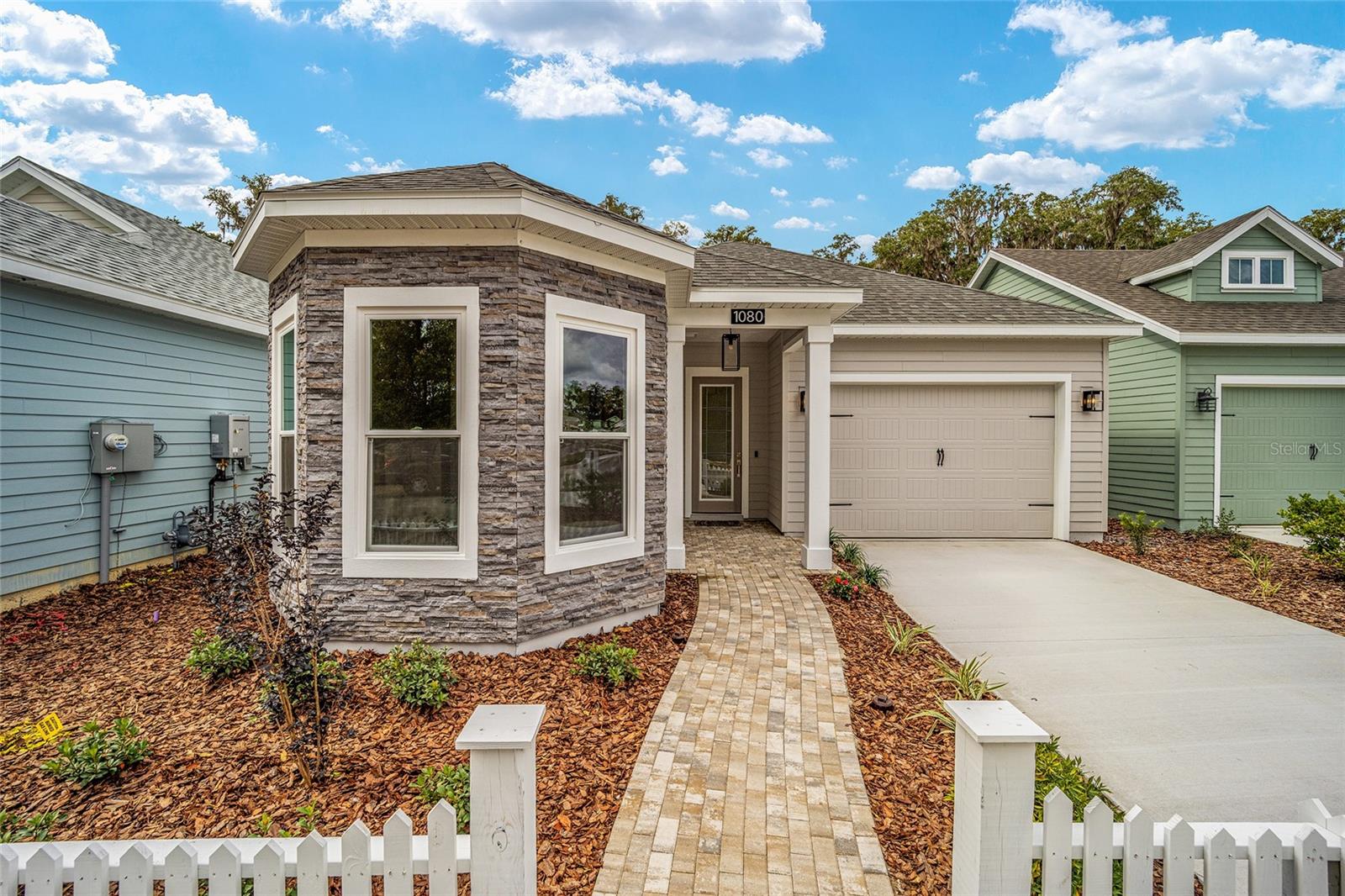 The Phoebe Model by Local Builder, Kara Bolton Homes is a spacious 3 bedroom/2 bath plus an enclosed flex/office space including skylights that bring in natural light and a 1 1/2-car garage. The home features wood look luxury plank flooring throughout the entire home. With10 ft ceilings and 8 ft doors, the open floor plan is spacious and inviting. The kitchen features ample lighting, granite countertops, undermount sink, solid wood cabinets with soft close drawers and stainless-steel appliances including a built-in oven/microwave combo, gas cooktop with vented hood, dishwasher and disposal. The Living Room features trey ceiling and glass doors leading to a covered porch/lanai area, creating an indoor/outdoor living space. The impressive Primary Suite includes a large walk-in closet with en-suite bathroom with an oversized walk-in shower, quartz topped double vanity and water closet. Enjoy endless hot water with your tankless, gas hot water heater. Security features include doorbell camera, smart deadbolt and front coach lights on photocell. Fully landscaped and irrigated with environmentally friendly Zoysia sod. The impressive exterior includes Hardie board siding and decorative pavers. The home is built with an engineered post tension foundation system. Low HOA only $110 per month covers COX high speed internet along with access to pool, tennis court and clubhouse and partial front maintenance. Minutes from shopping and dining, only 4.5 mi to North Florida Regional Hospital, 11 mi to Shands and VA Hospitals and 8 mi to UF. Please verify current school zones with ACSB.