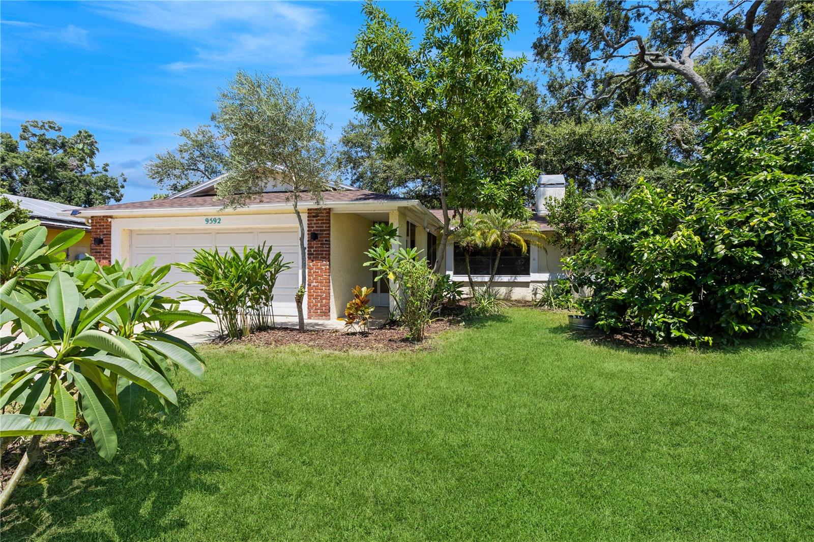 Welcome to this beautifully maintained home offering approximately 1,500 square feet of comfortable living space. NO HOA and NOT IN A FLOOD ZONE. Featuring three spacious bedrooms and two full bathrooms, this split plan residence is designed for both functionality and charm. The generous kitchen includes a cozy eat-in area and has a brand-new dishwasher and microwave. Freshly painted interiors and updated light fixtures throughout the home create a bright and modern ambiance. The inviting living room centers around a classic brick-framed wood-burning fireplace—perfect for cooler fall evenings. Enjoy peace of mind with recent upgrades, including a new roof in 2025 and a newer air conditioning system in 2019. Stylish wood-look laminate flooring extends throughout the home, with tile in the wet areas—no carpet in sight! The spacious, private lot is enhanced with mature fruit trees, offering a tranquil outdoor retreat. Relax or entertain in the screened-in lanai, ideal for enjoying Florida’s beautiful weather year-round. The washer and dryer are included for your move-in ease. Situated outside of a flood zone, this home is just a short drive to pristine beaches, excellent dining, and lively local attractions. This home is in an unincorporated area of Largo and may be suitable for short-term rentals.