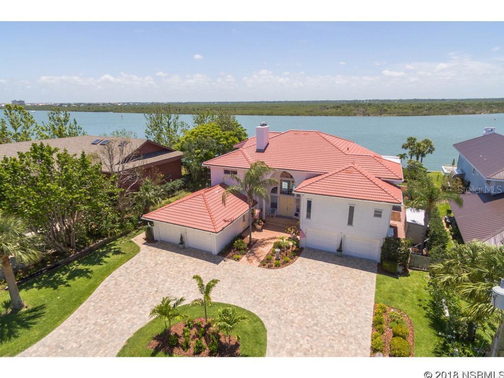 Enjoy warm breezes and sunset views over the Intracoastal Waterway. Direct 100â waterfront provides plenty of dockage for a yacht and multiple water toys, with Ponce Inlet and deep sea fishing nearby. This stunning 5,380 sq. ft. Mediterranean home is large enough for your whole family. A two-story foyer greets you with a fireplace and beautiful views of the sparkling pool and waterway, through the large windows in the formal dining room. Enjoy watching the passing boats and dolphins play through the massive windows in the family room. The chefâs kitchen and large butler pantry will delight all cooks; custom KraftMaid cabinets, 4 ovens, 2 dishwashers, GE Monogram 6 burner gas stove, KitchenAid stainless steel refrigerator and huge granite-topped center island & breakfast bar. In addition to the ample entertaining space are 5 bedroom en-suites, with two bedroom suites, conveniently located on the first floor. From the main hallway, take the elevator to 3 private bedroom en-suites, including an upper loft level. Spectacular Intracoastal views from your luxurious master suite: private balcony, double walk-in closets, wide-plank hardwood floors, large spa-like bath with soaking tub, shower, double sinks & toilet room. The covered riverside patio has retractable sunshades and newly refinished, heated pool. Need space for your toys? This home offers two, 2- car garages and tons of storage. NEW 2017 tile roof, rebuilt dock & boat house, pavered driveway, along with many updated features. This is a MUST SEE home. Click on video link for video. ;Water: City