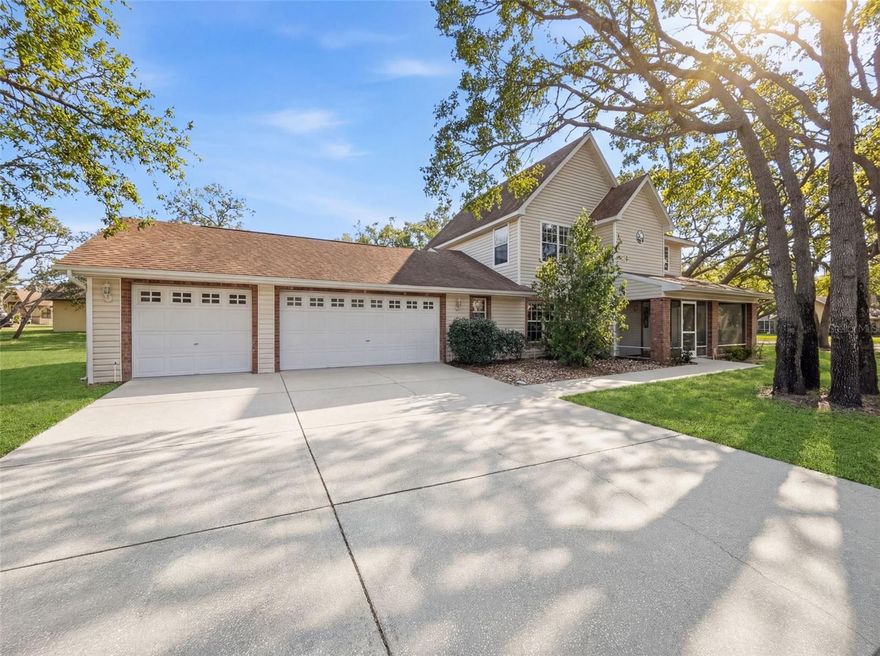 Nestled on over a half-acre corner lot in desirable Preston Hollow, this impressive two-story pool home offers over 2,000 square feet of living space with 3 bedrooms, 2 full baths, and a 3-car garage. Designed for comfortable living and entertaining, all three bedrooms are located upstairs, including a spacious primary suite featuring a cathedral ceiling, generous closet space, and an updated en suite bath.
The main level features a huge eat-in kitchen complete with a breakfast bar, full appliance package, and large pantry, plus an inside utility room for added convenience. The inviting family room includes a built-in bar and half bath, making it perfect for entertaining guests. Step outside to your screened, heated pool overlooking lush, mature landscaping that creates a private, peaceful setting. Additional highlights include two new AC systems and an irrigation system to keep the grounds looking their best. Ideally located close to the Suncoast Parkway, this home offers easy access to Tampa, the International Airport, shopping, dining, and more. This exceptional property combines space, function, and location—don’t miss the opportunity to make it yours!