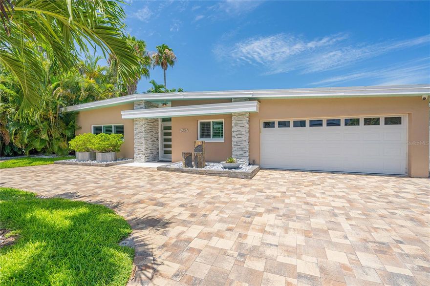 This 1st Class Resort Style Retreat is truly exceptional! No expense was spared in the whole house renovation that was completed in 2021. New impact rated doors/windows, new water, sewer and electric from the street in, new 80' wide elevated seawall, new HVAC/Ducts, new foam insulation, new 50' concrete floating dock with full hookup (so bring the Big Boat) on this deep water safe harborage. Product selection on the interior finishes throughout include custom cabinetry, Cambria counters, High-end Appliances, custom walk in closet systems, solid core doors and a bonus morning kitchen/pantry and extensive smart home technology. Tropical Landscape creates privacy to enjoy the fully refinished salt water oversized pool surrounded by travertine pavers and screen enclosed with 500 sq ft of covered outdoor living space. Fantastic Floor Plan and Architectural elements you'll enjoy are vaulted ceilings complimented by all the natural light from the mostly floor to ceiling windows showcasing the natural surroundings, Italian Tile floors throughout give the home seamless transition to all the amazing space. Come enjoy the vibrancy the tourist bring to the island and the relaxed nature of those that live here full time. It's truly a one of a kind area...so much to do and see....so much to let go and relax! Just 10 mins to Downtown St Petersburg and the trendy restaurants and wonderful Museums. Tampa Int'l is a quick 35 mins away making Business or Casual travel a breeze.