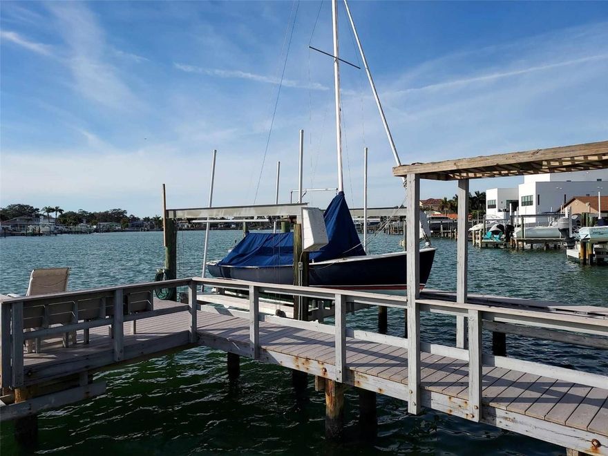 Investors dream located within Yacht Club Estates.  End of cul de sac 2 story floorplan with 4 or 5
bedrooms 4 baths, 2 car garage, large balconies front and back. Prime location on the water. Large backyard with covered patio, wet bar, heated pool & spa, beautiful water view, as well as a huge garden.  Deck and boat lift are also a bonus with this home.